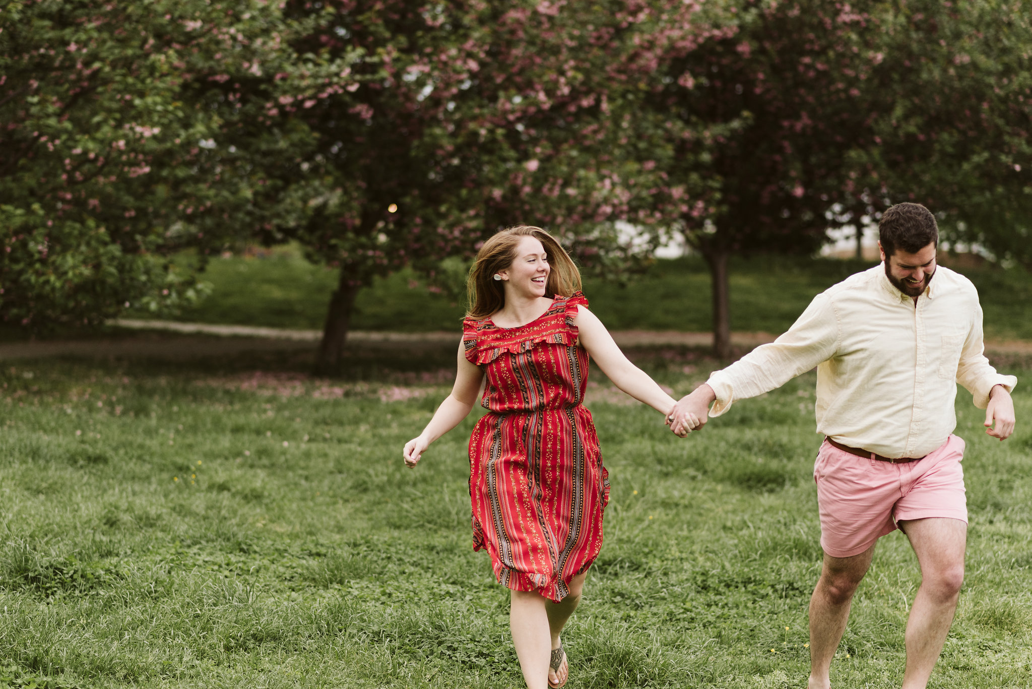 Engagement Photos, Patterson Park, Baltimore, Maryland Wedding Photographer, Casual, Fun, Nature, Bride and Groom Holding Hands and Running Through the Grass