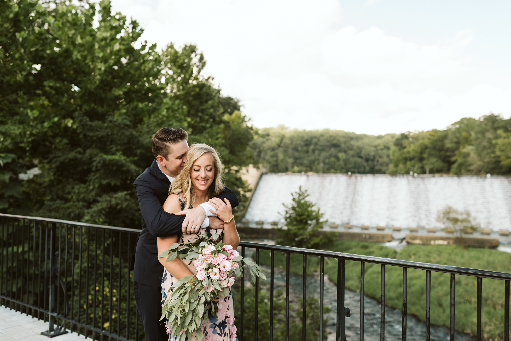 Outdoor Wedding, Casual, Simple, Lake Roland, Baltimore, Maryland Wedding Photographer, Laid Back, DIY Flowers, Bouquet with Eucalyptus and Lisianthus, Bride and Groom Hugging on Bridge