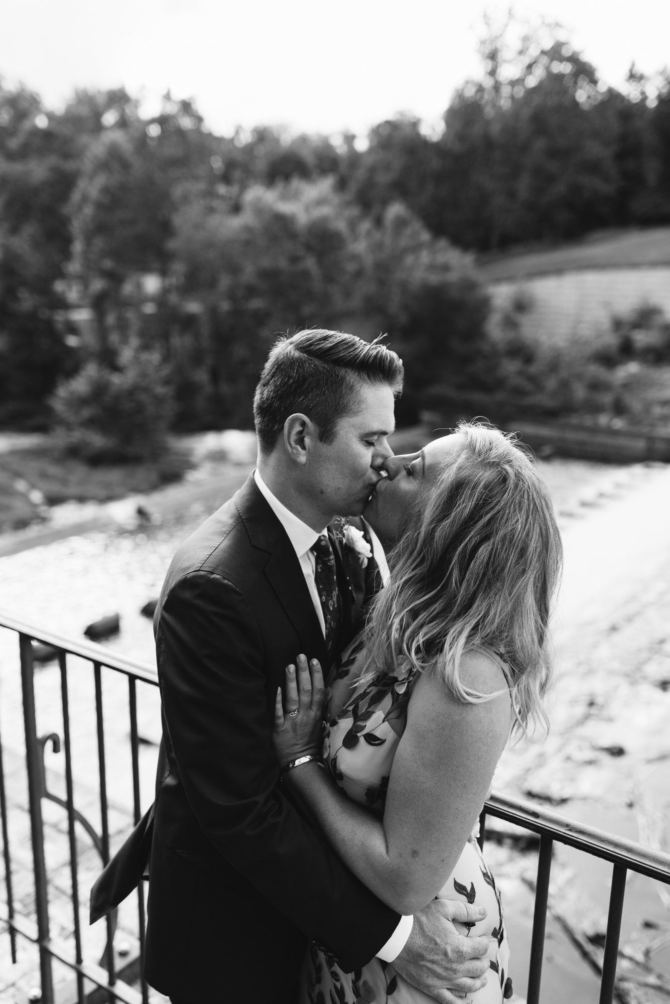 Pop-up Ceremony, Outdoor Wedding, Casual, Simple, Lake Roland, Baltimore, Maryland Wedding Photographer, Laid Back, Bride and Groom Kiss on Bridge, Black and White Photo