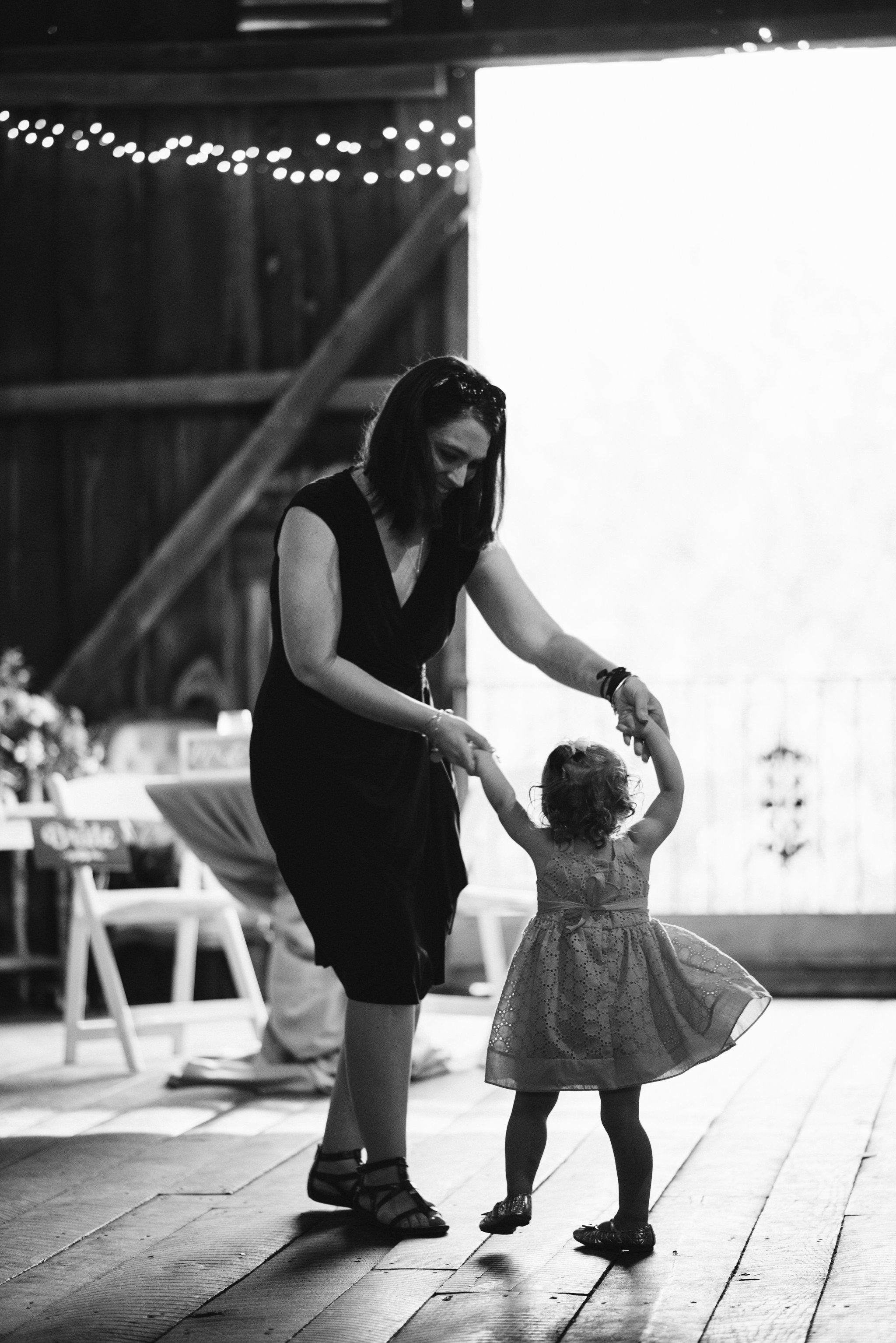 Rocklands Farm, Maryland, Intimate Wedding, Baltimore Wedding Photographer, Sungold Flower Co, Rustic, Romantic, Barn Wedding, Wedding Guest Dancing with Child, Black and White Photo