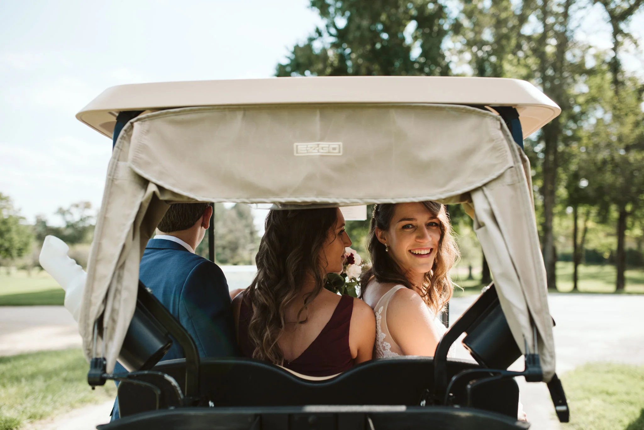 Phoenix Maryland, Baltimore Wedding Photographer, Eagle’s Nest Country Club, Classic, Romantic, Bride Looking Back from Golf Cart with Friends