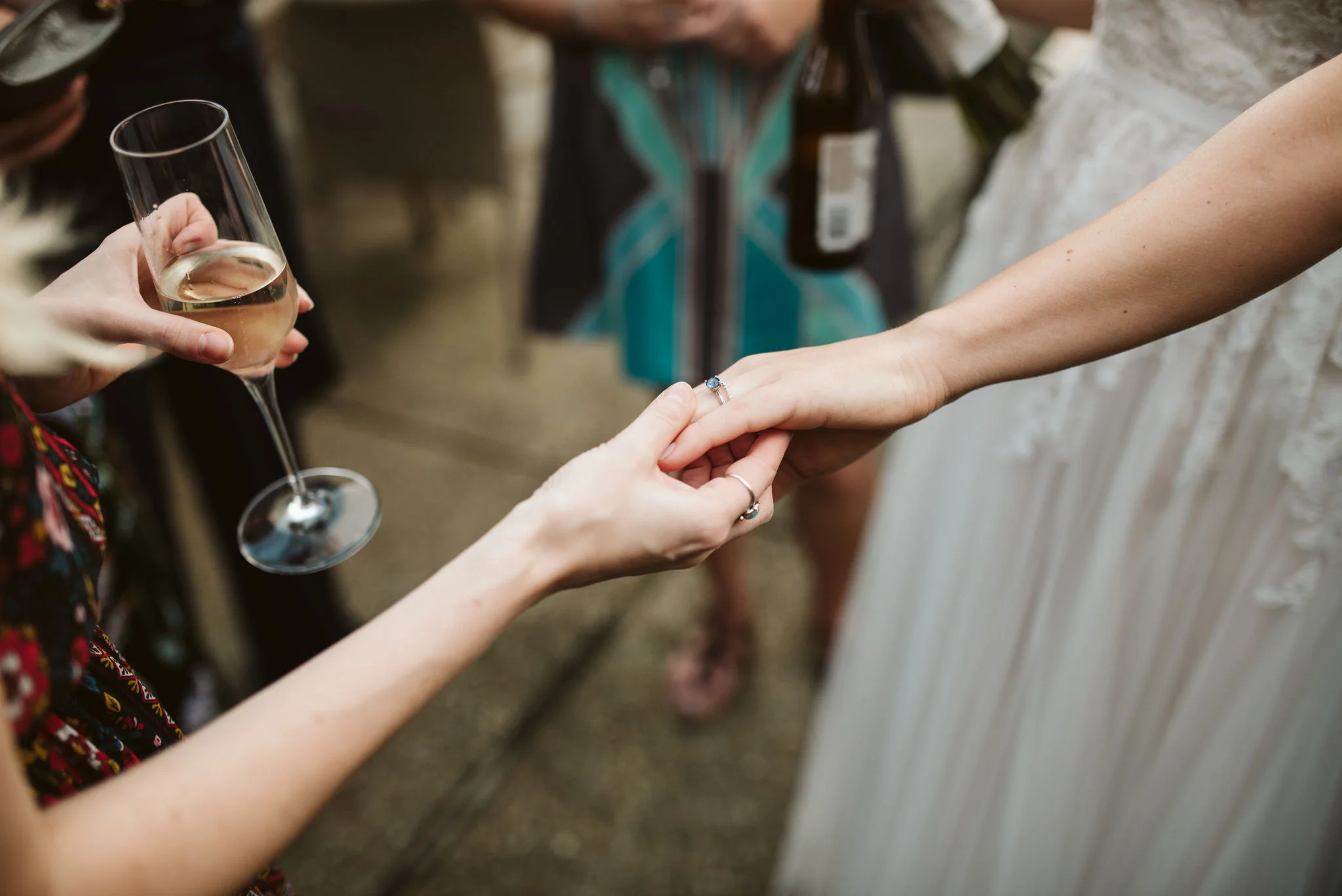 Phoenix Maryland, Baltimore Wedding Photographer, Eagle’s Nest Country Club, Classic, Romantic, Spring, Bride Holding Hands with Friend, Wedding Guests Admiring Brilliant Earth Rings