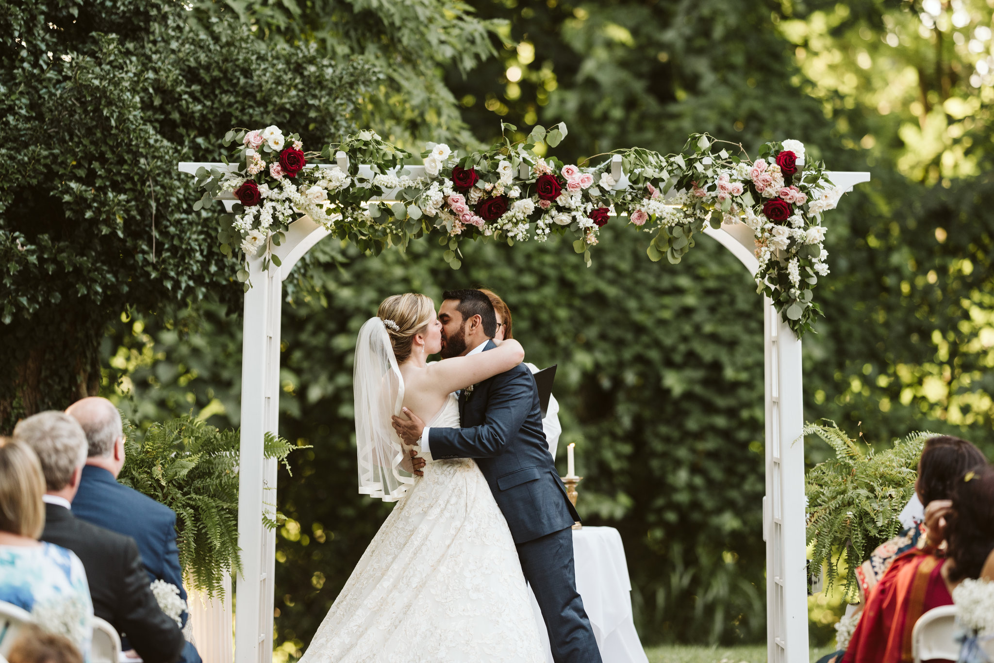  Ellicott City, Baltimore Wedding Photographer, Wayside Inn, Summer Wedding, Romantic, Traditional, Bride and Groom First Kiss Under Floral Archway, Just Married 