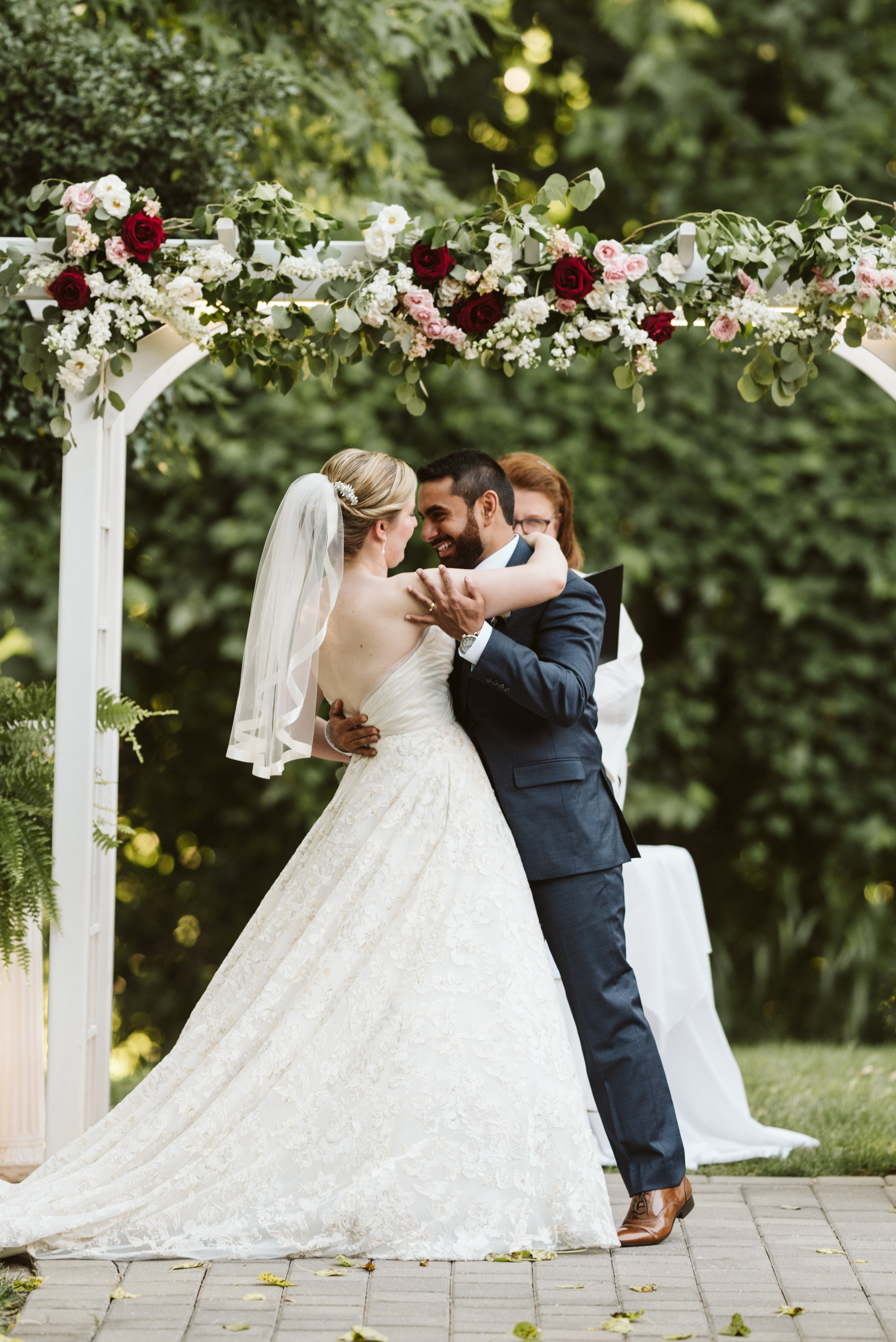  Ellicott City, Baltimore Wedding Photographer, Wayside Inn, Summer Wedding, Romantic, Traditional, Bride and Groom First Kiss Under Floral Archway, Just Married, Matthew Christopher Bridal 