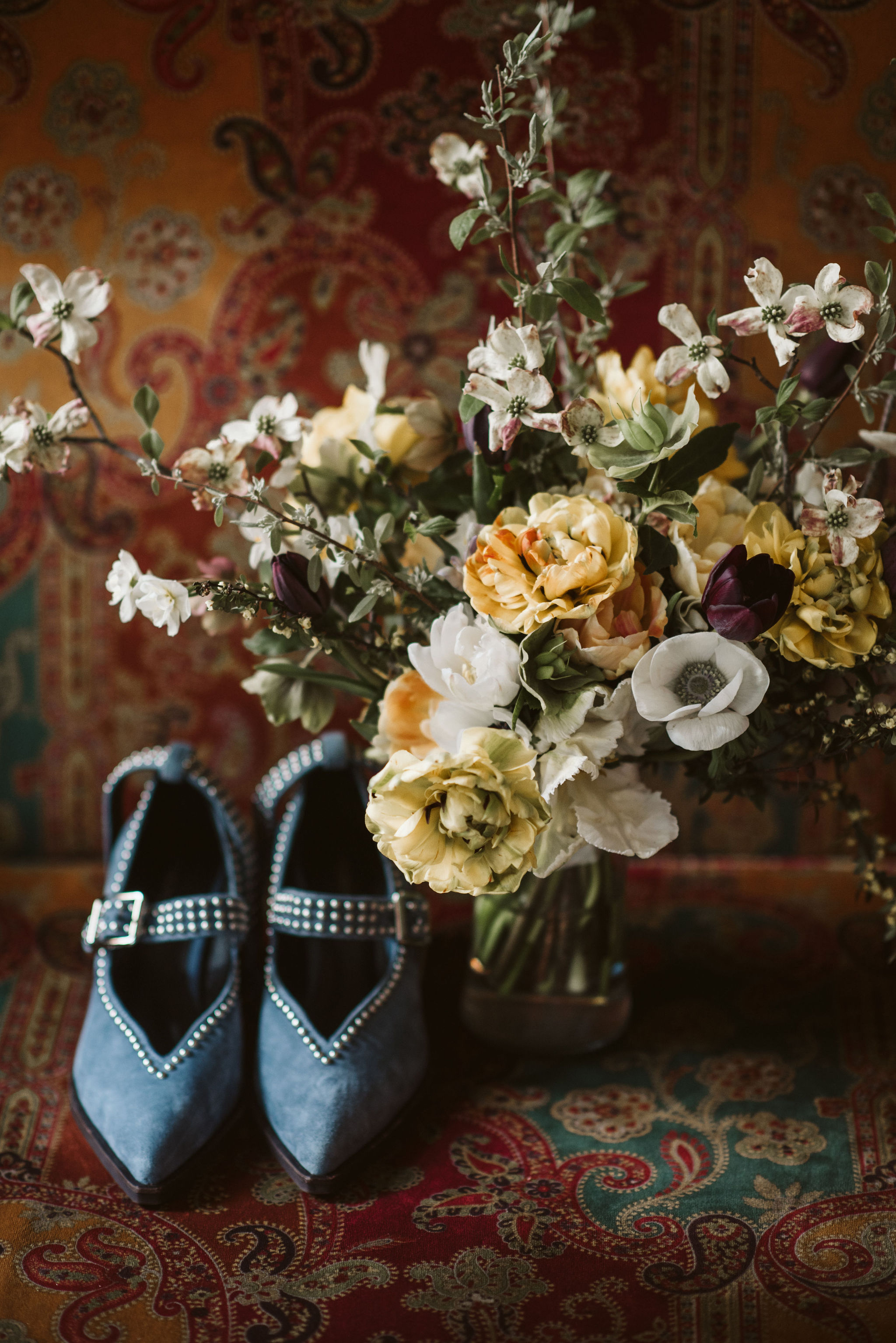  Washington DC, Baltimore Wedding Photographer, Alexandria, Old Town, Jewel Tone, Romantic, Modern, The Alexandrian Autograph Collection Hotel, Sungold Flower Co, Floral arrangement next to blue studded suede heels 