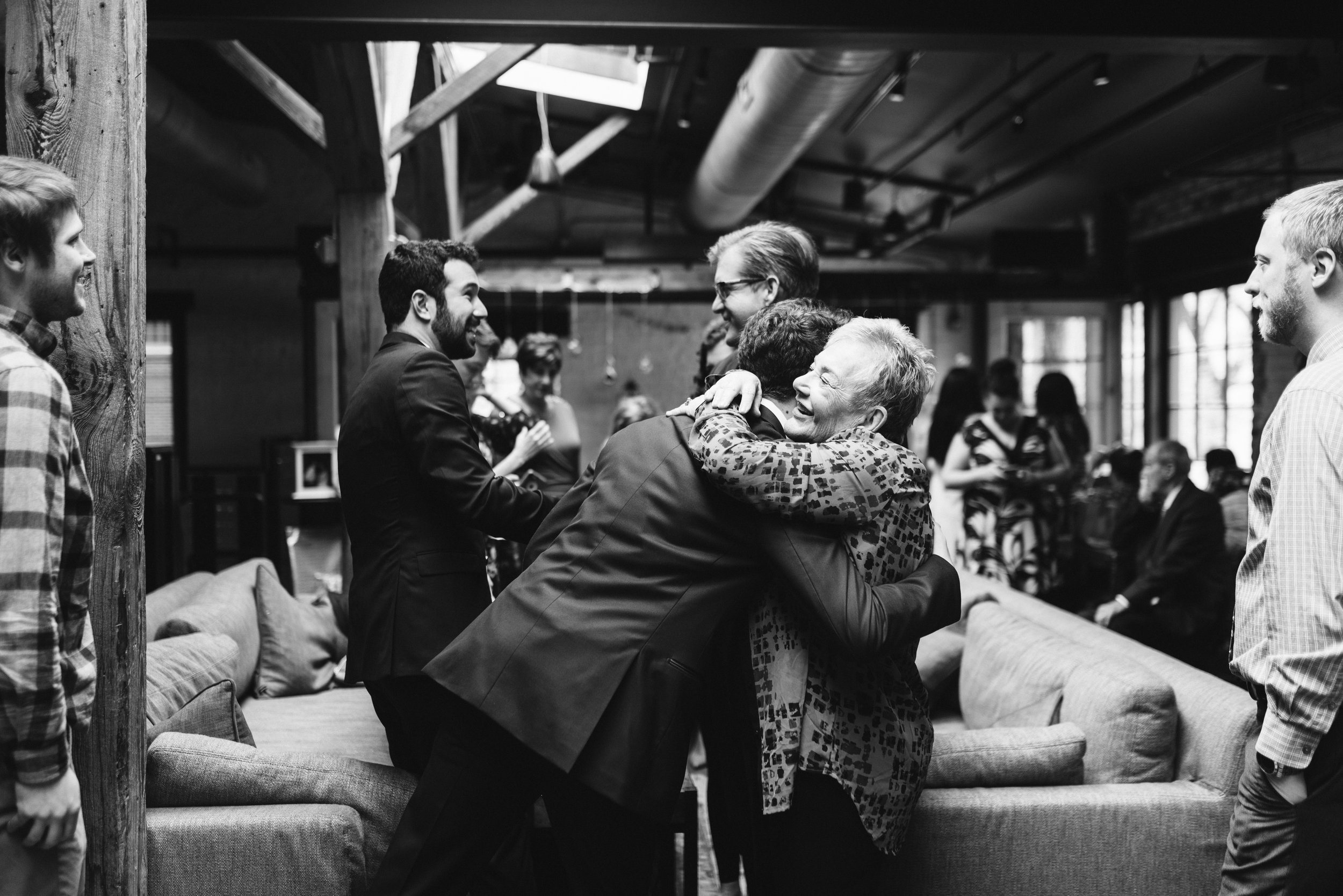  Washington DC, Baltimore Wedding Photographer, Alexandria, Old Town, Jewel Tone, Romantic, Modern, Virtue Feed &amp; Grain, Guests Smiling and Hugging, Black and White Candid Photo 