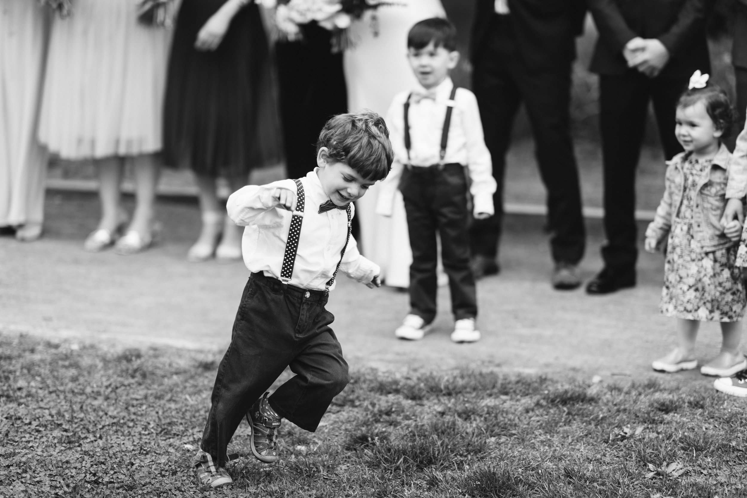 Washington DC, Maryland Wedding Photographer, Alexandria, Old Town, Jewel Tone, Romantic, Modern, Little boy in suspenders running the the park, Black and White Photo 