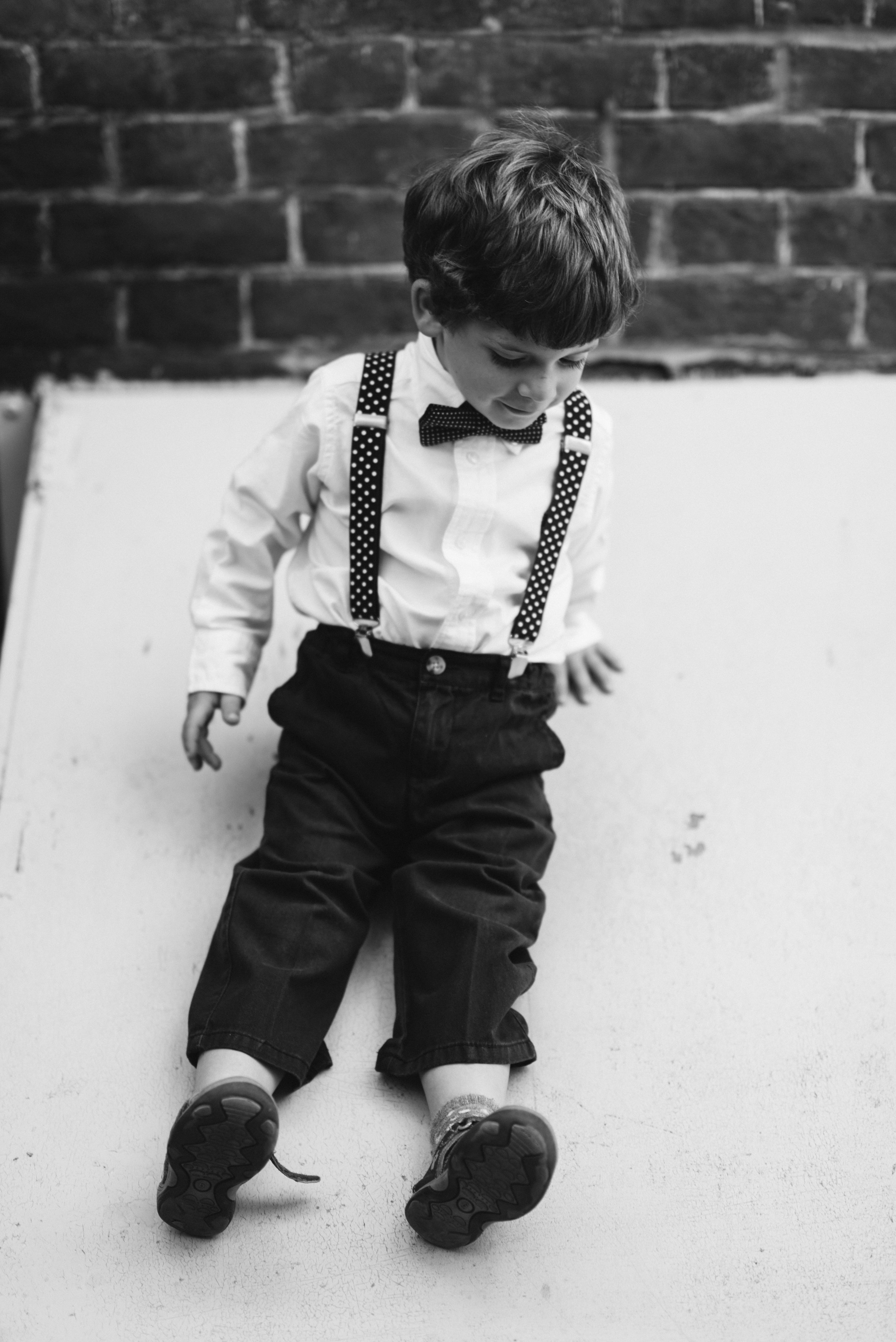  Washington DC, Baltimore Wedding Photographer, Alexandria, Old Town, Jewel Tone, Romantic, Modern, Black and white photo of little boy in suspenders 