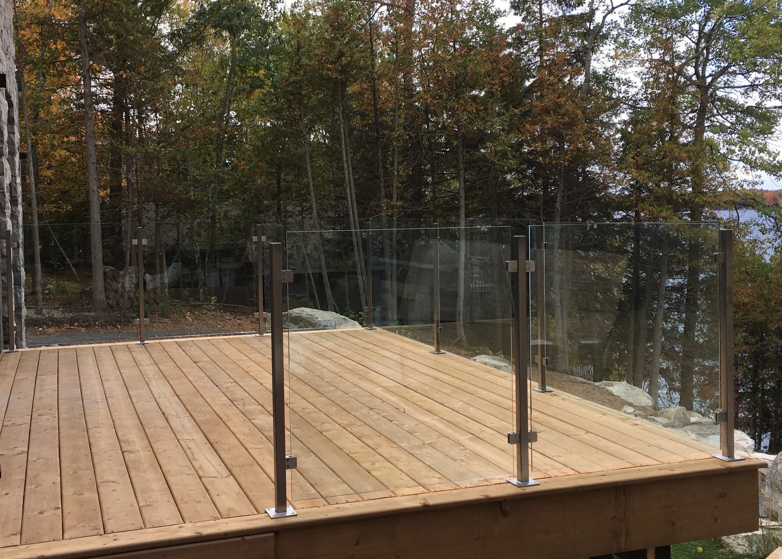  Top surface mount stainless posts and stainless glass clips, 10mm clear glass exterior guard rail. Modern Cottage, Stoney Lake 