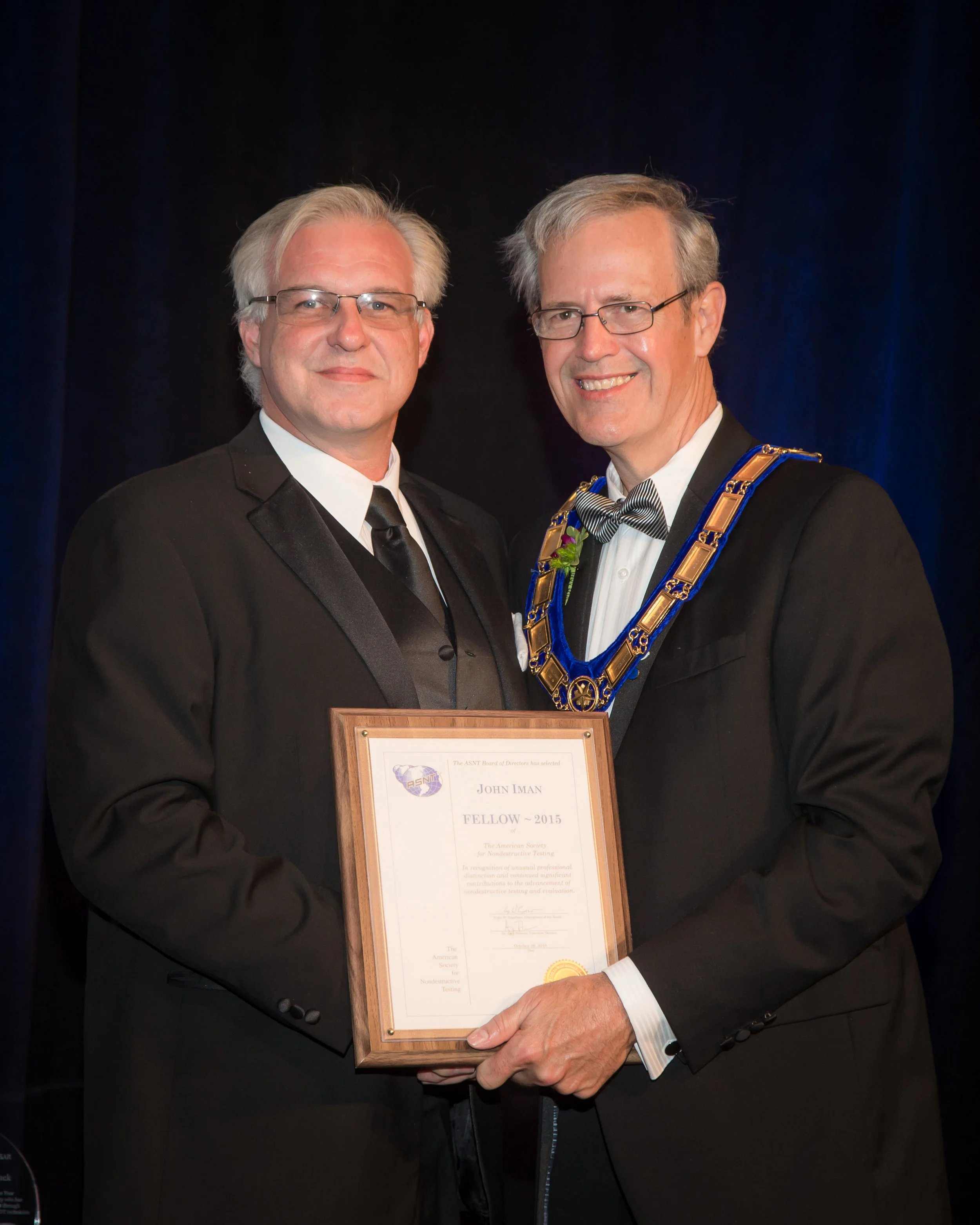 John T. Iman receives ASNT Fellow Award from ASNT past-president L. Terry Claussing.