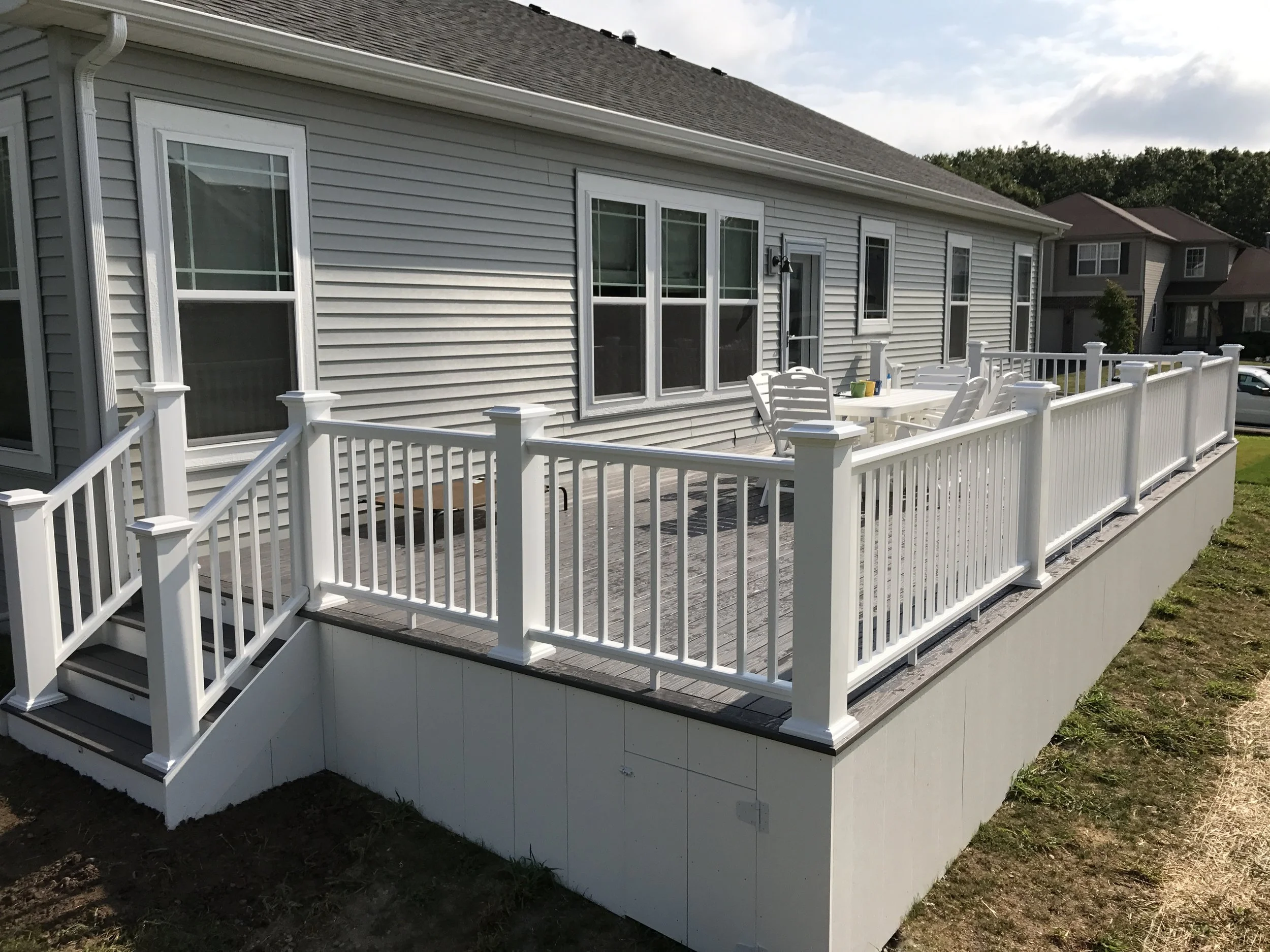  Azek deck located in Lake Geneva, WI  colors are Island Oak Harvest collection with white trim. 