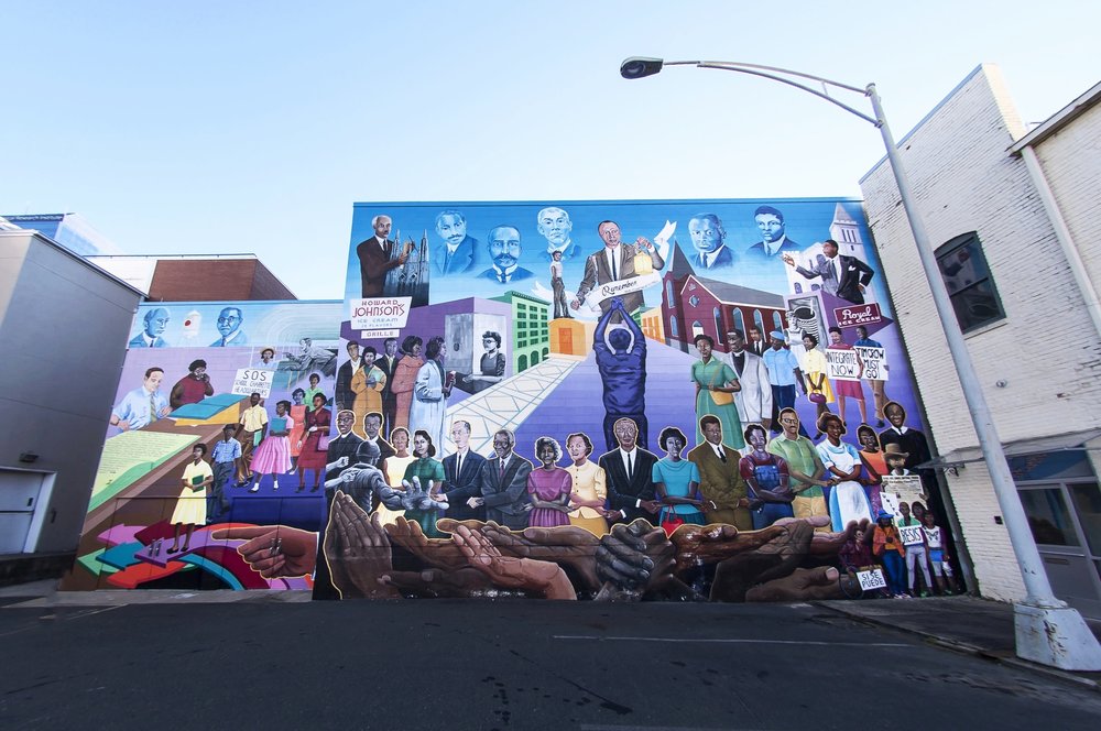 A mural in downtown Durham depicting the history of the Civil Rights Movement in North Carolina. It is on a brick wall and depicts scenes and prominent people from the period.
