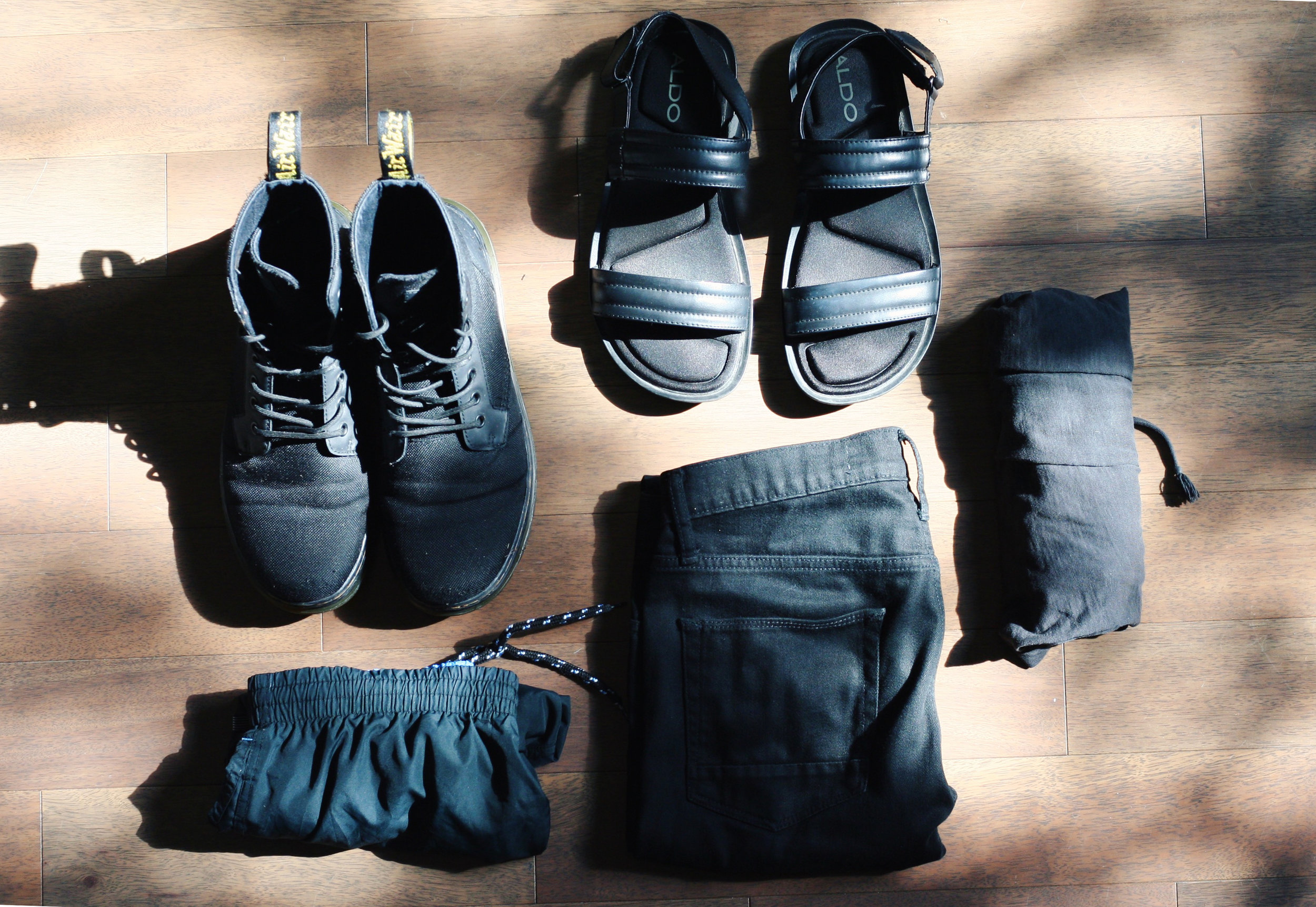 One pair of Dr. Martens canvas boots, Aldo sandals, one swimsuit, denim shorts, and jersey shorts for relaxing after a long day