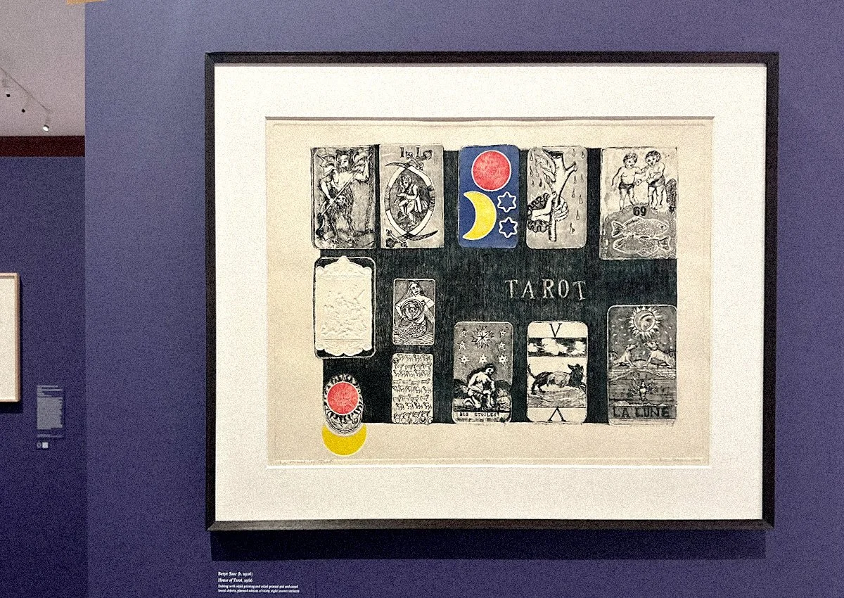 A Framed image on a wall of tarot card drawings