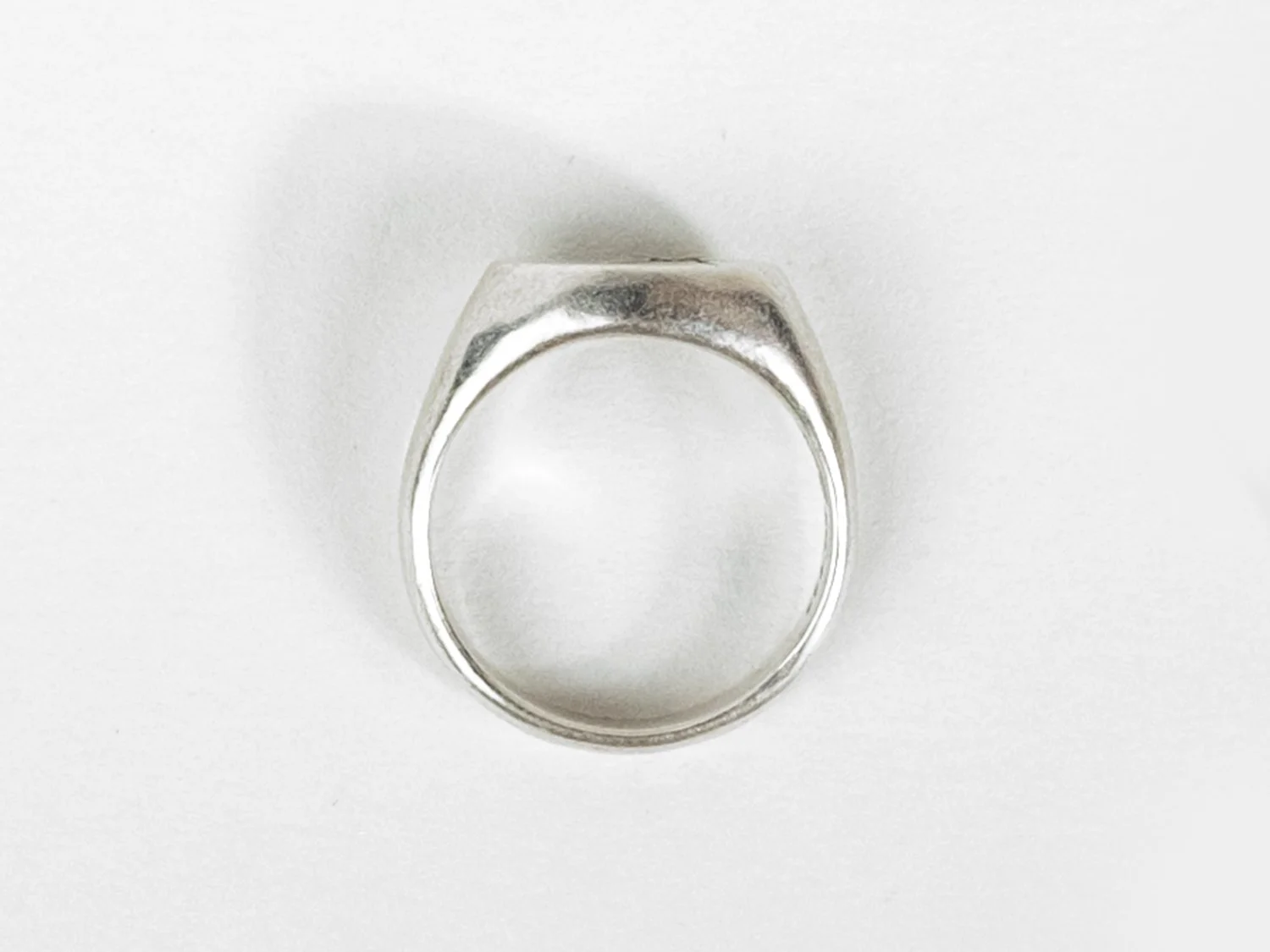 Overhead view of a wide silver signet ring