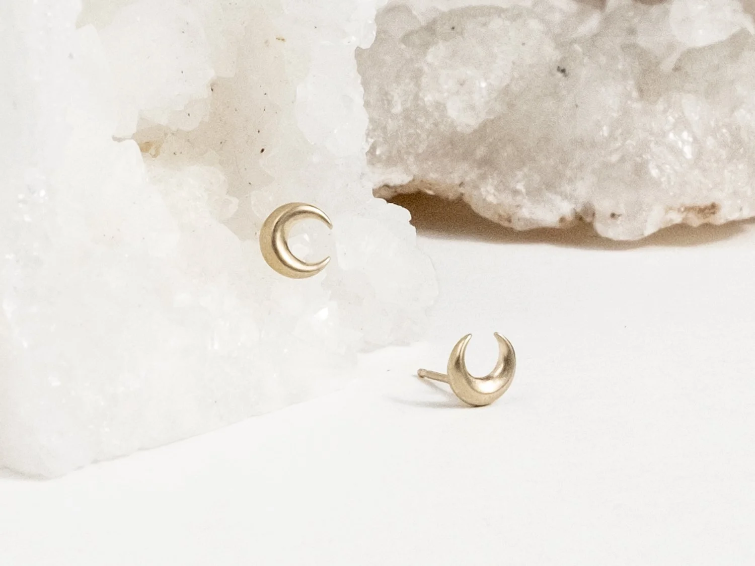 Pair of gold crescent moon stud earrings