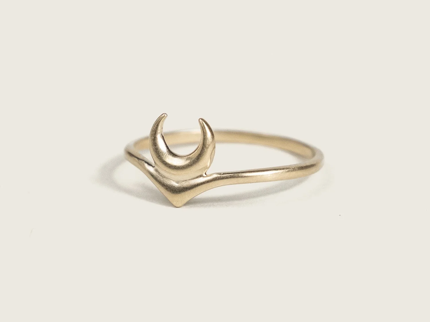 Curved gold ring with crescent moon