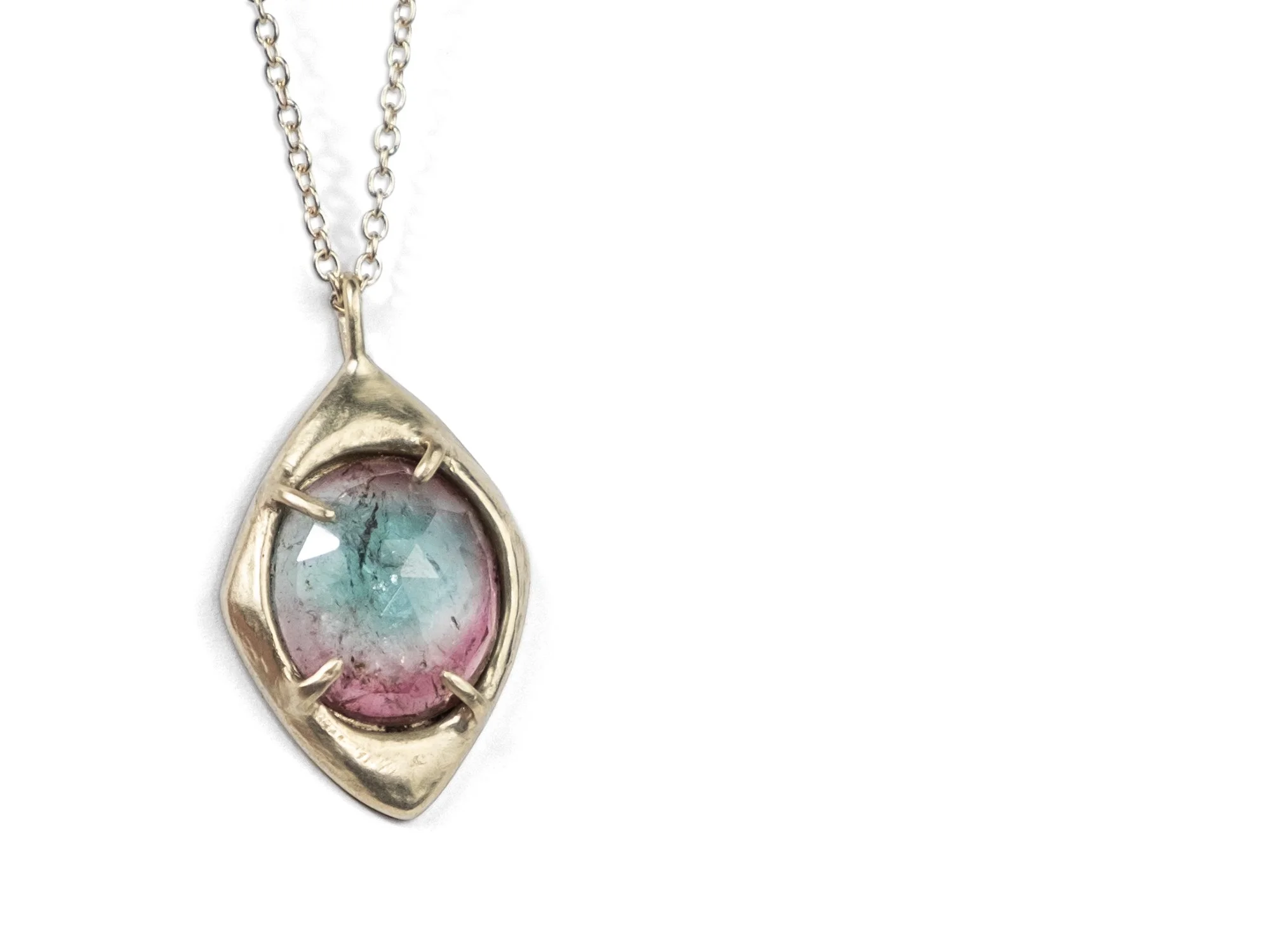 Heavy gold pendant necklace with a tourmaline stone in the center