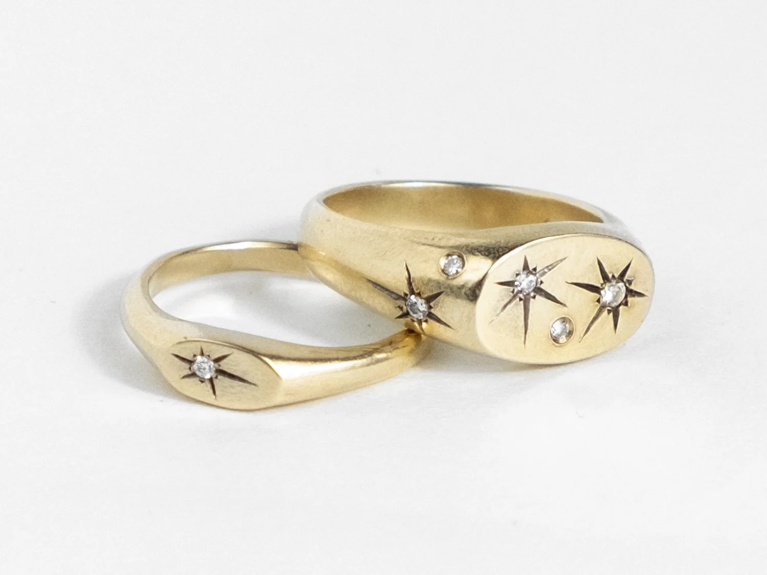 Pair of small and large signet rings covered in star-set diamonds (Copy)