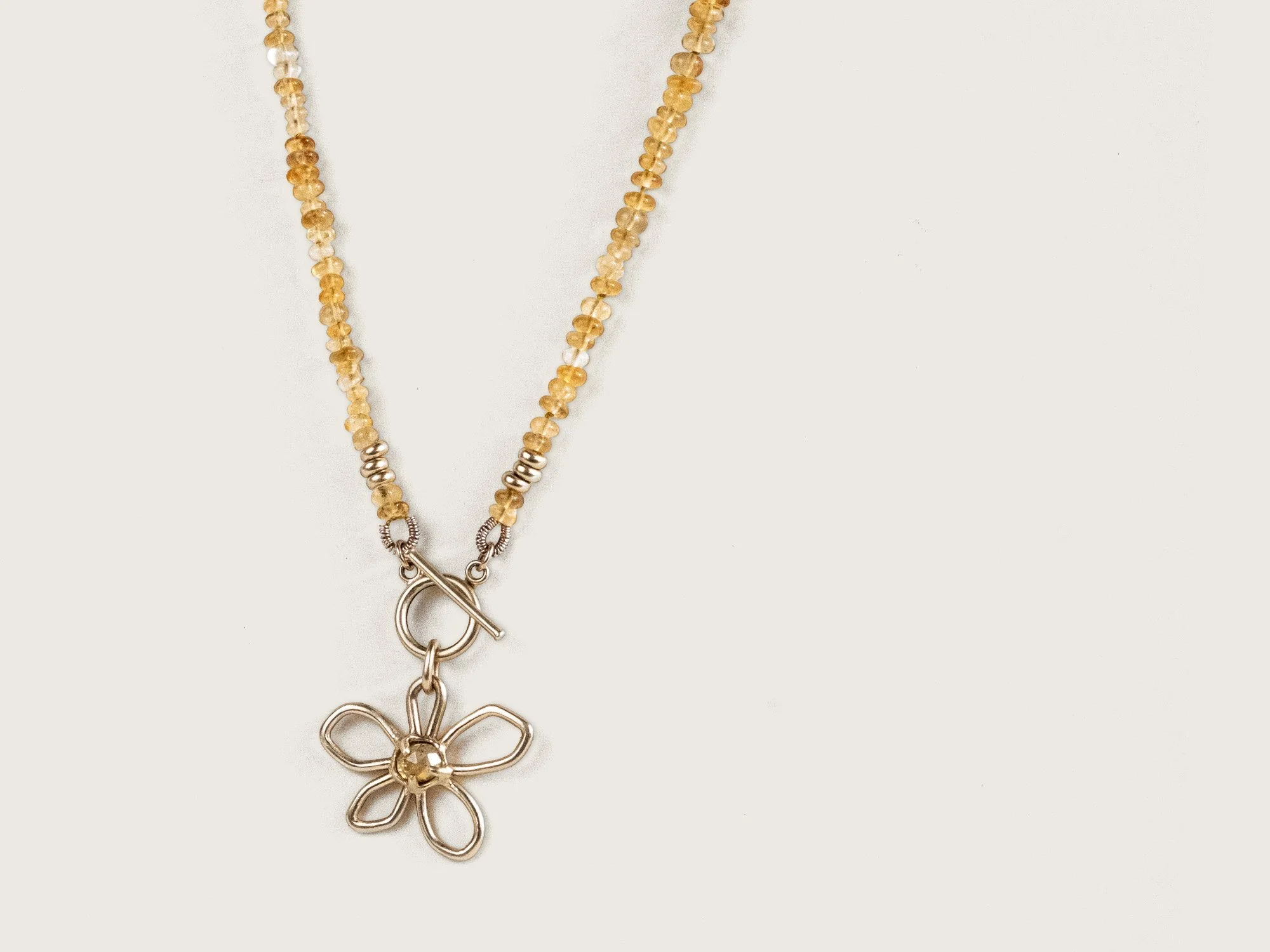 SG25_Beaded WildflCitrine beaded necklace with a gold flower hanging from the centerower Necklace 4.jpg