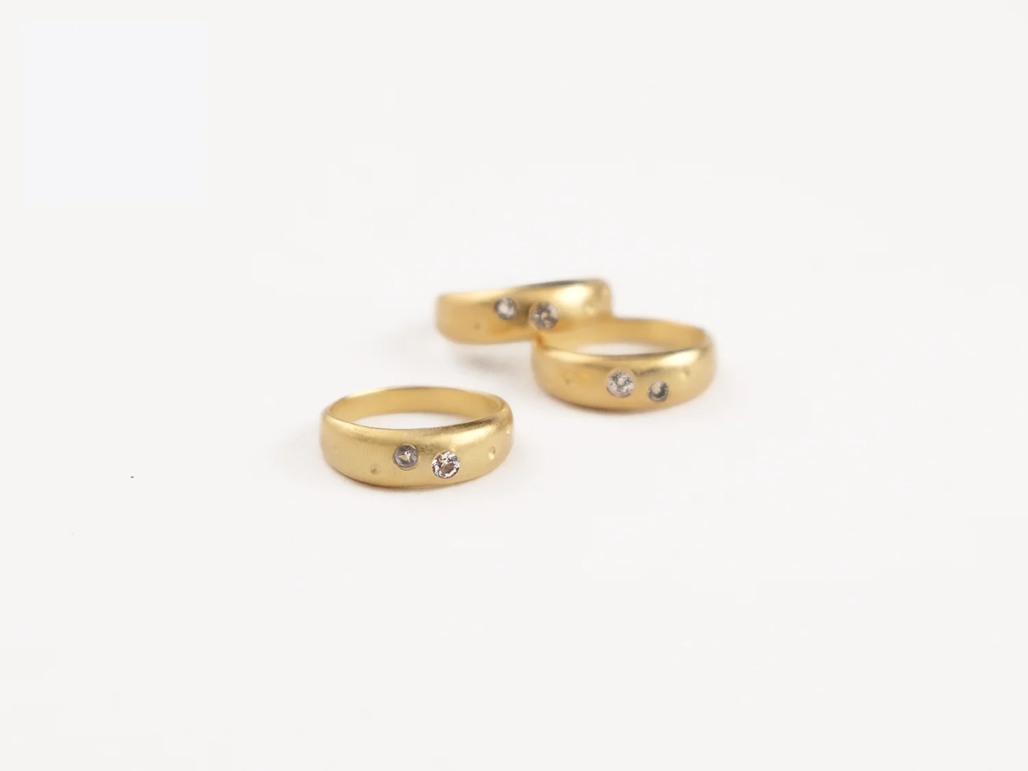 Cygnus rings in gold and white topaz by Sara Golden Jewelry.