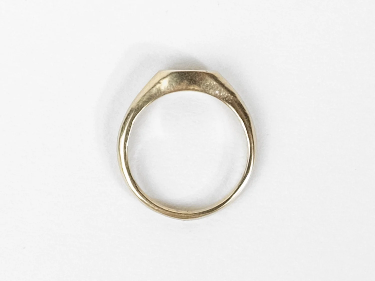 Overhead view of a slim gold signet ring (Copy)