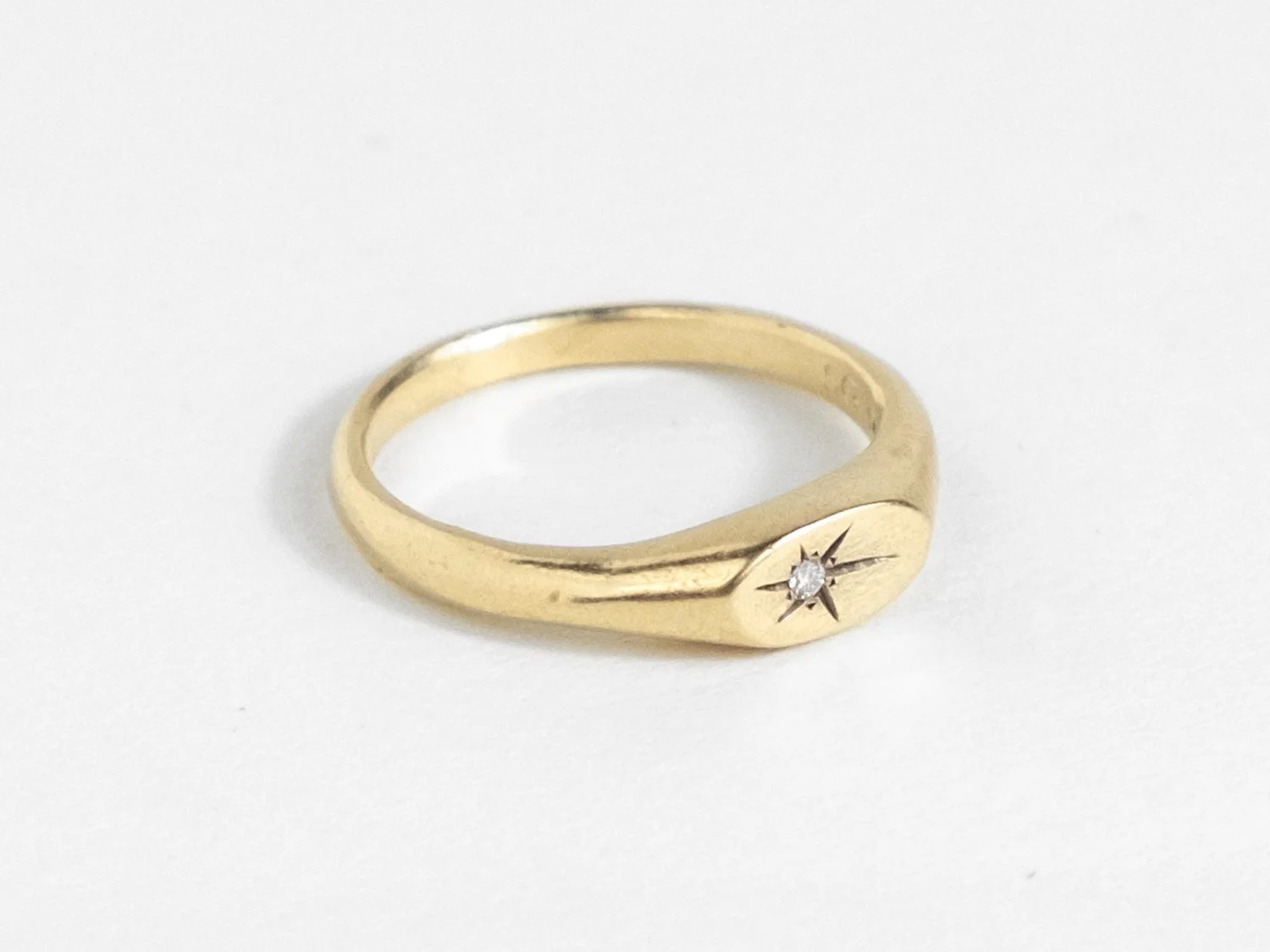 Slim gold signet ring with a star-set diamond on the top face (Copy)