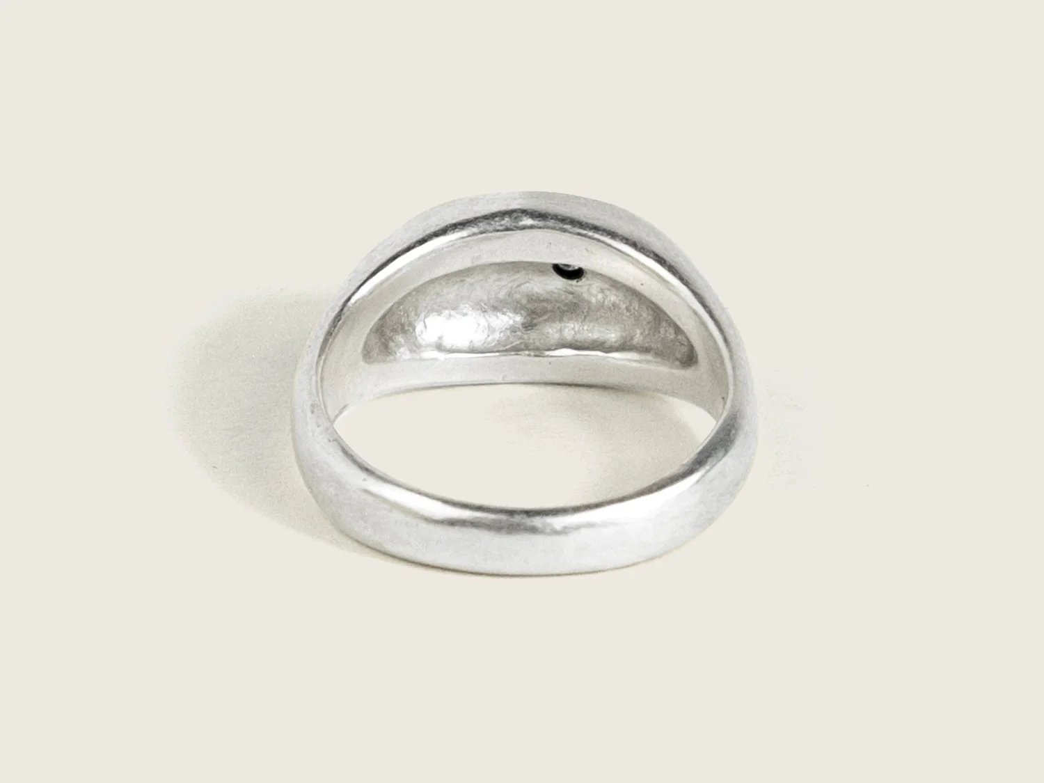 Back view of a wide silver signet ring