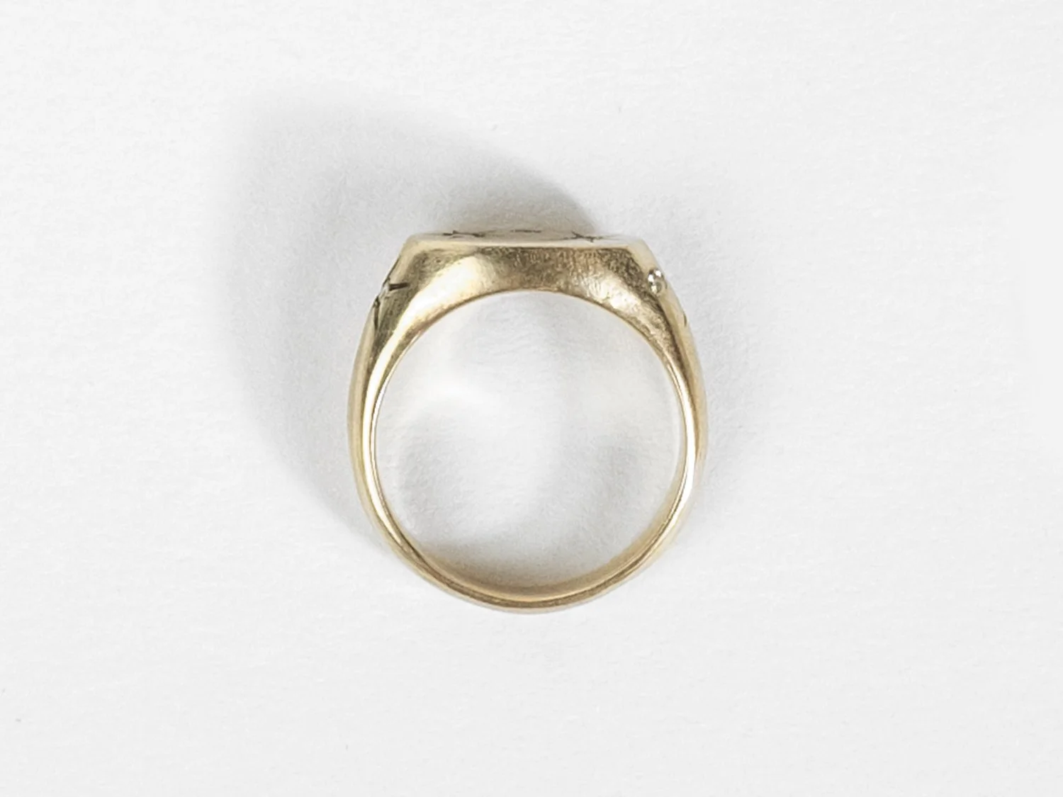 Overhead view of a wide gold signet ring