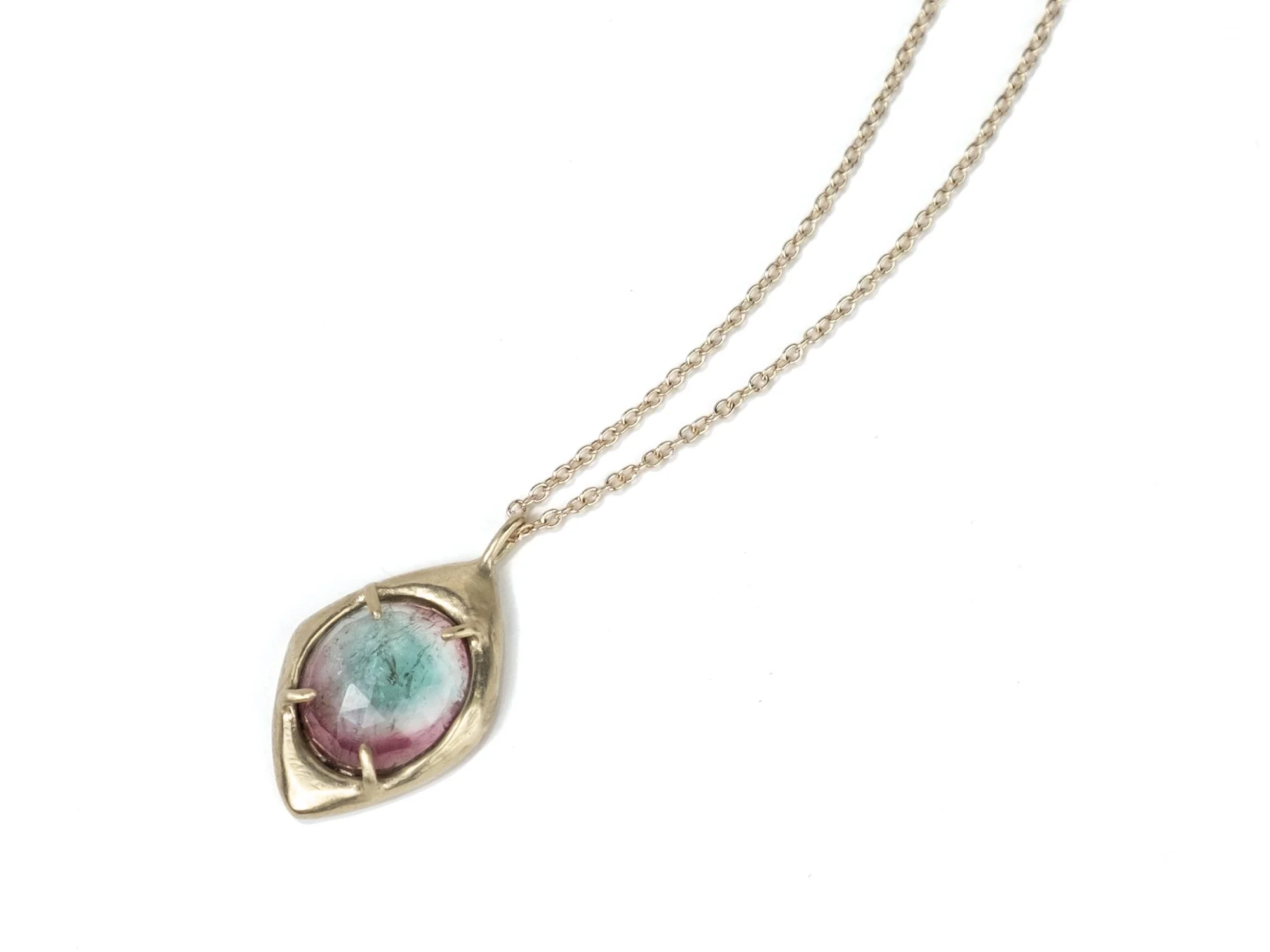 Heavy gold pendant necklace with a tourmaline stone in the center