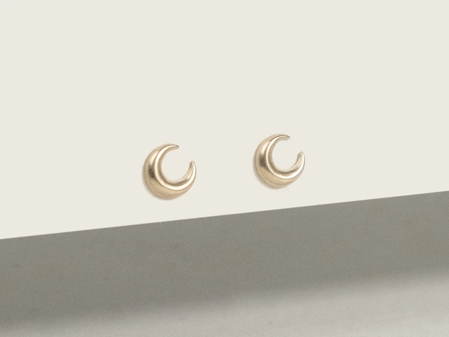 Pair of gold crescent moon stud earrings