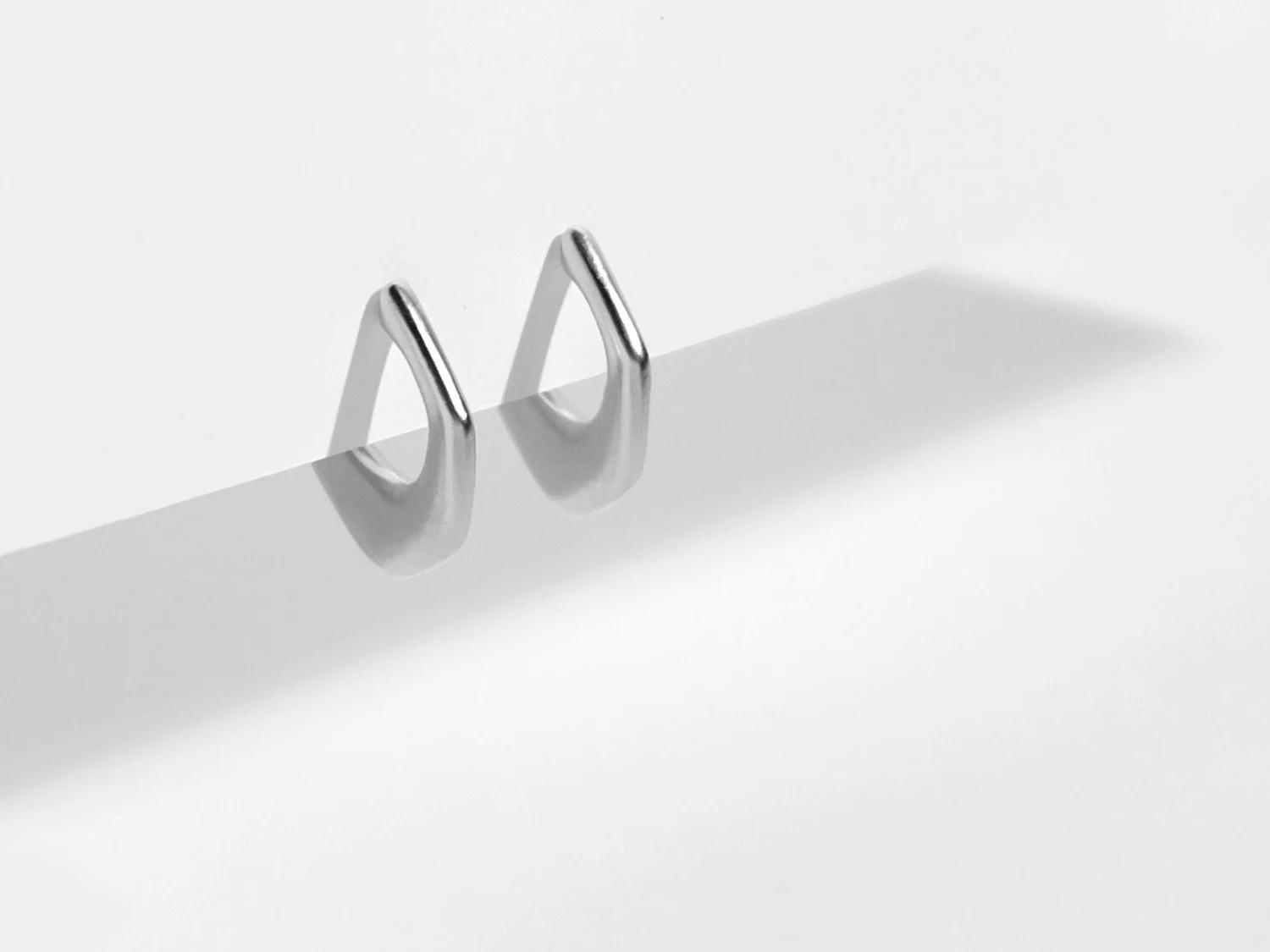 Organically-shaped huggie-style earrings in sterling silver