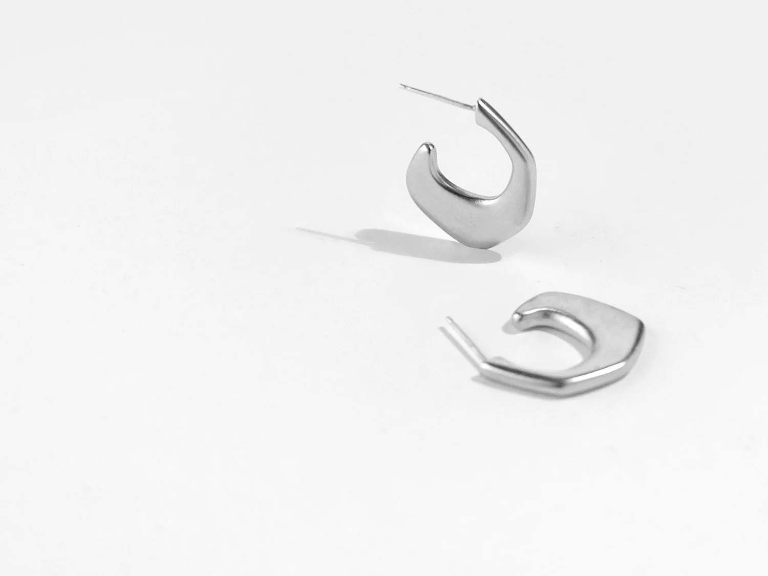 Organically-shaped huggie-style earrings in sterling silver