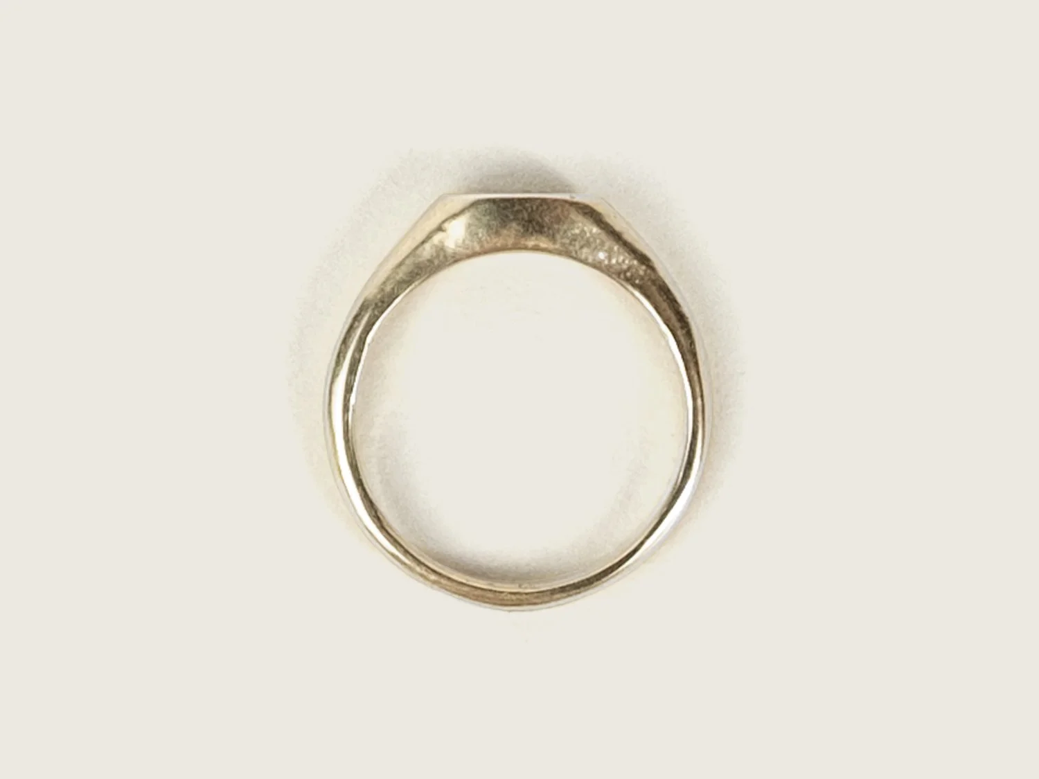 Overhead view of a slim gold signet ring