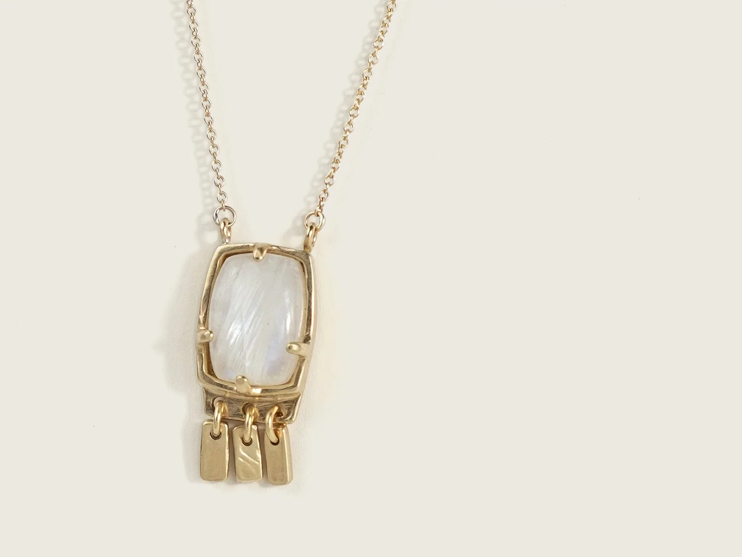 Close up detail of a 14k gold and moonstone pendant necklace by Sara Golden Jewelry