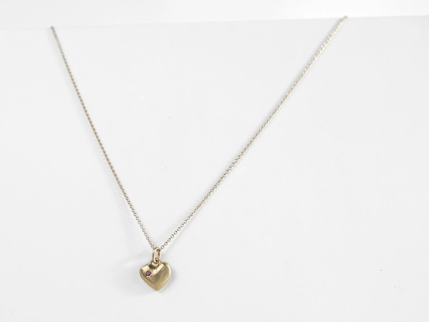 14k gold puffy heart charm on a chain