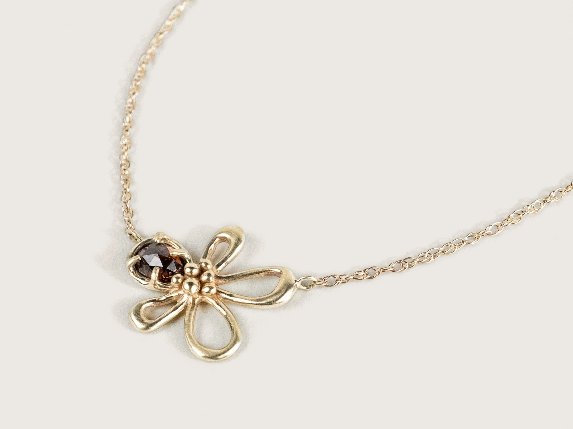 SG25_WildfloweGold necklace with a center gold flower and zircon petalr Necklace 3.jpg