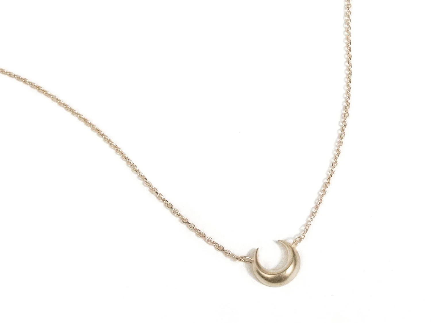 Delicate gold necklace with an upturned crescent moon