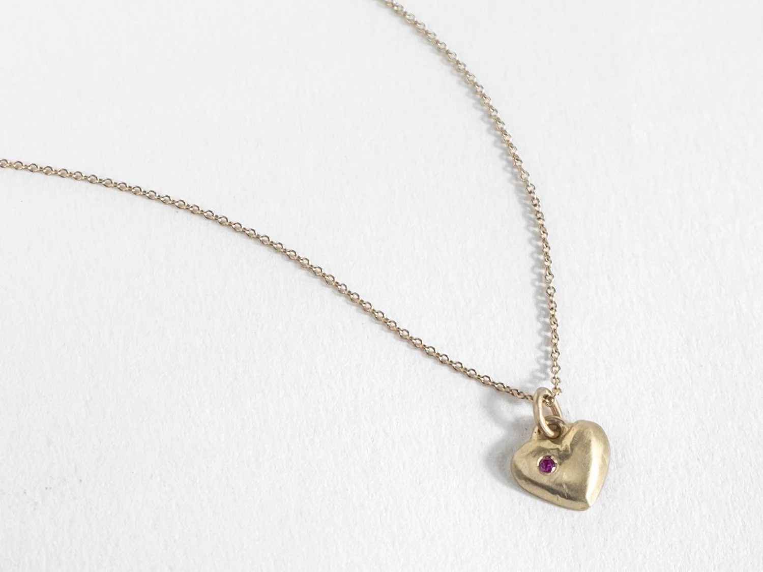 14k gold puffy heart charm on a chain