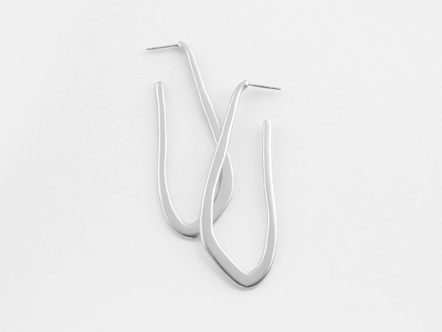 Long, organically-shaped hoop earrings in silver by Sara Golden Jewelry