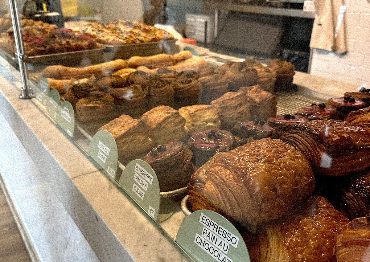Rows of pastries behind a glass partition