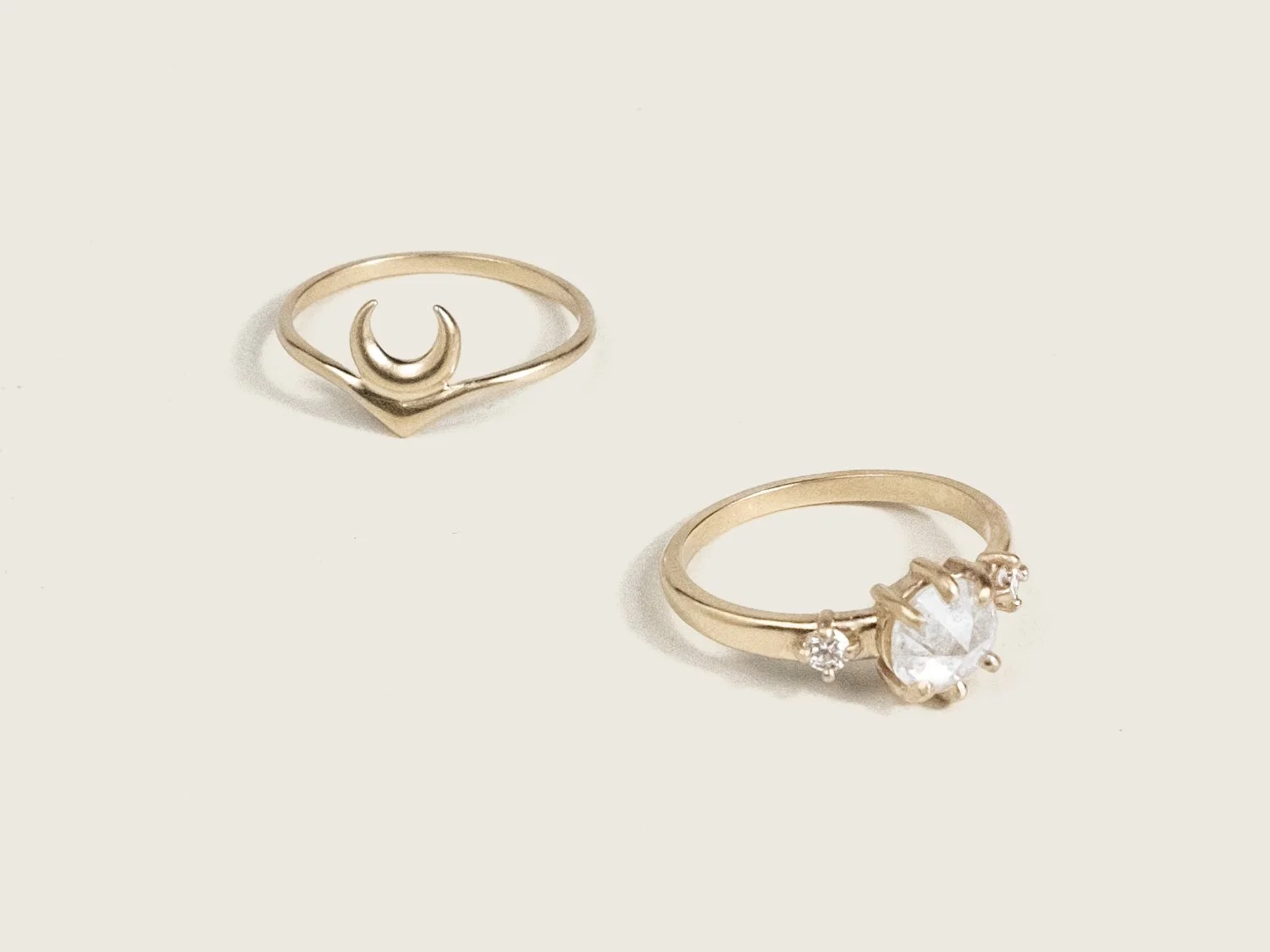 Gold ring with crescent moon and icy white diamond ring