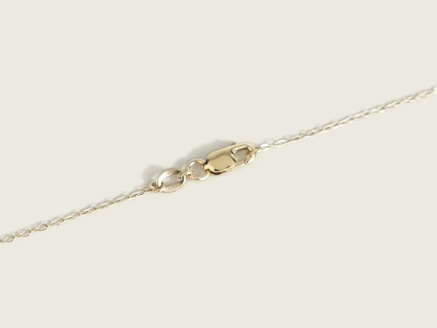 Close up of a gold lobster-style closure