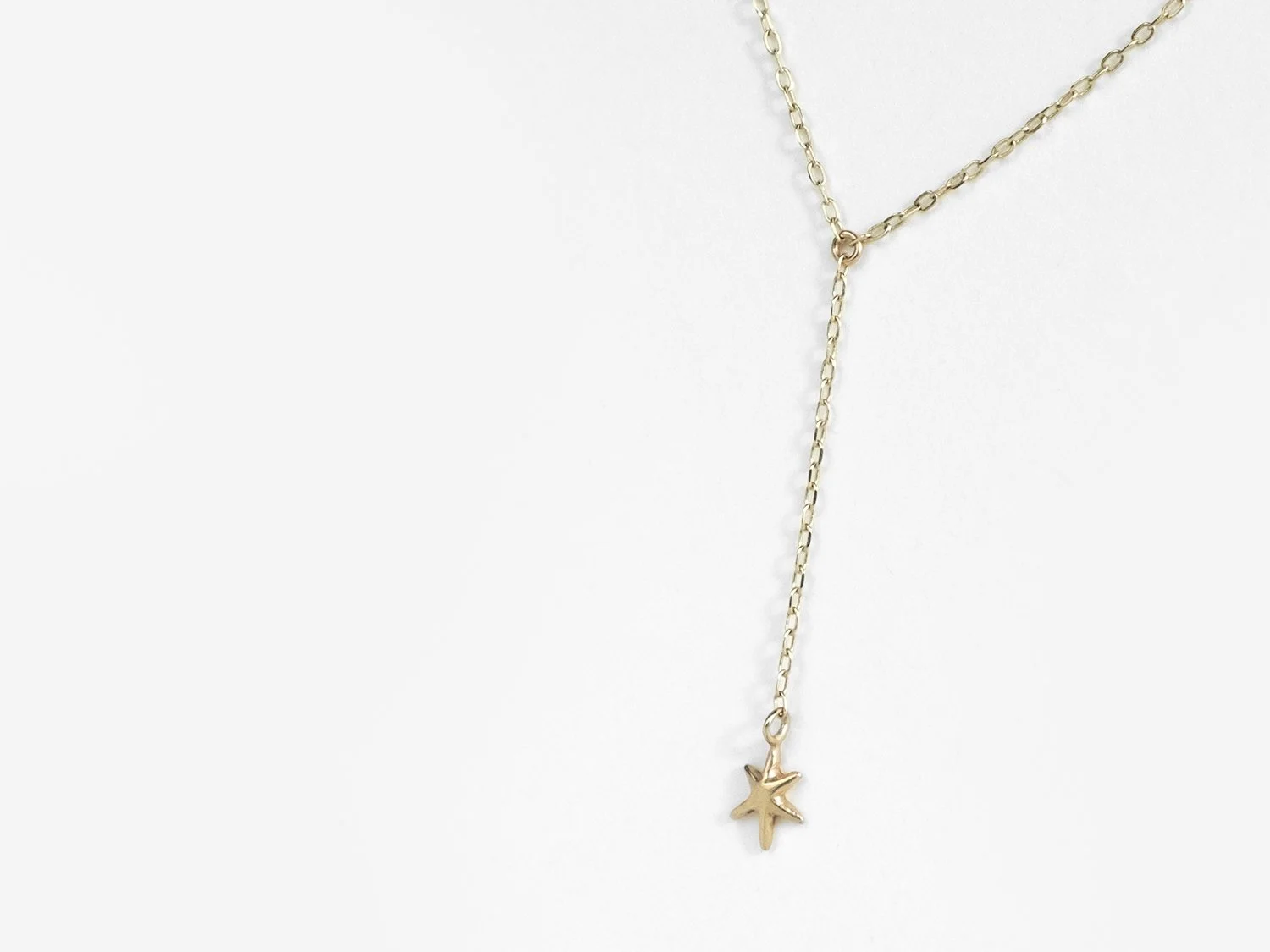Gold lariat-style necklace with a single hanging star