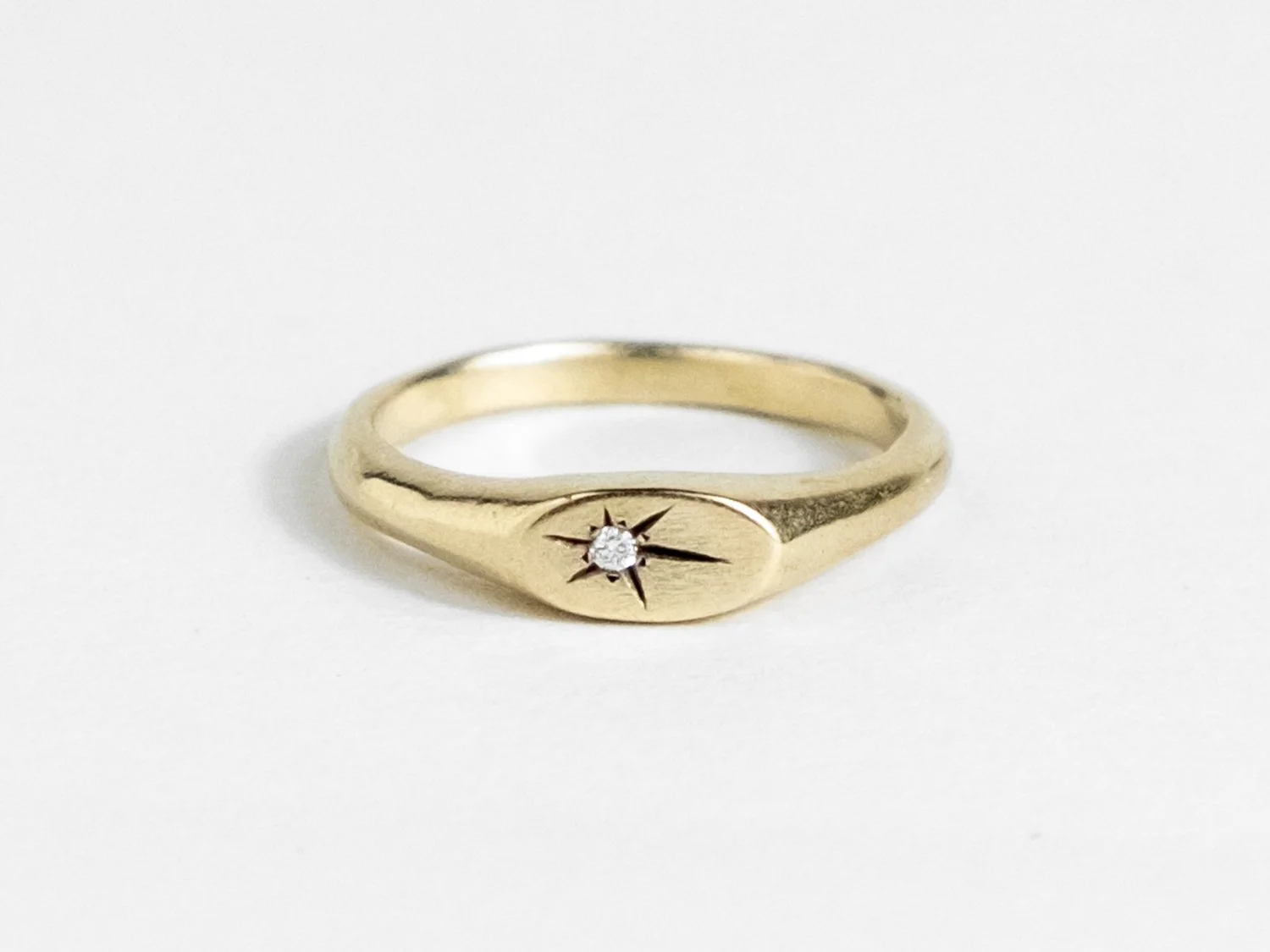 Slim gold signet ring with a star-set diamond on the top face (Copy)