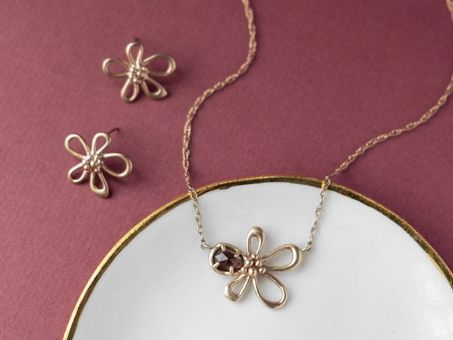 Gold flower-shaped earrings and necklace