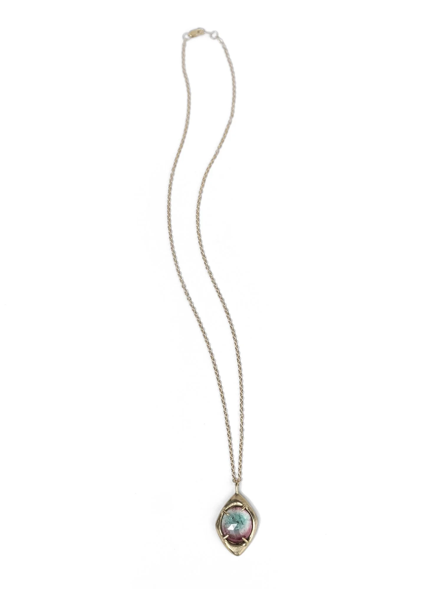 Heavy gold pendant necklace with a tourmaline stone in the center
