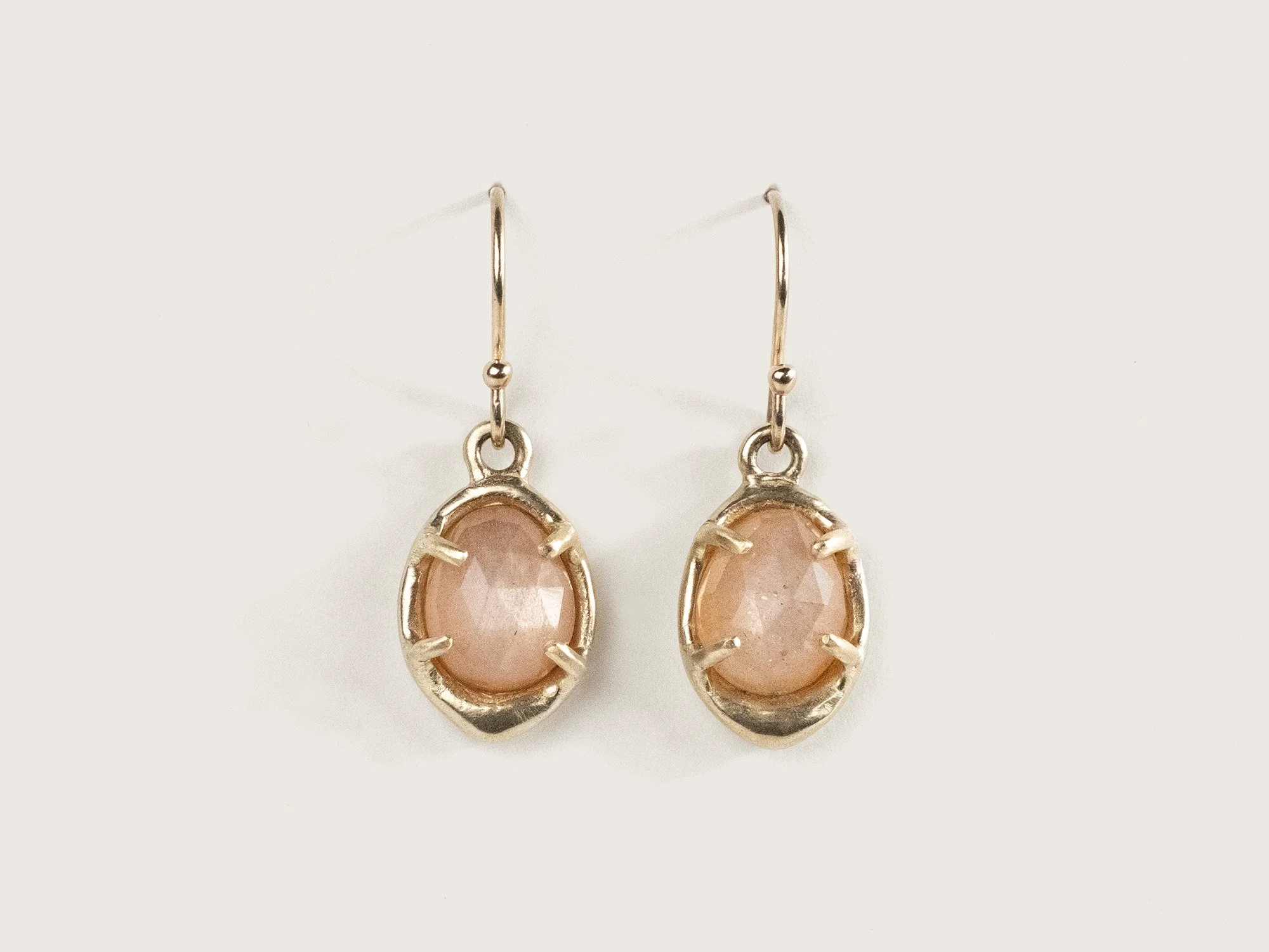 Gold earrings with oval peach moonstones