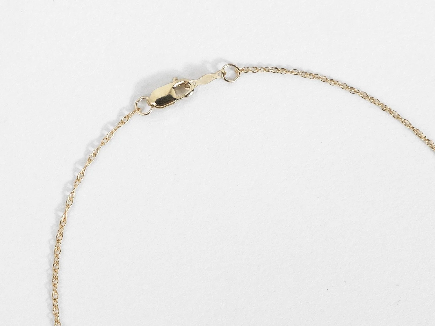Close up of the closure on a gold chain necklace