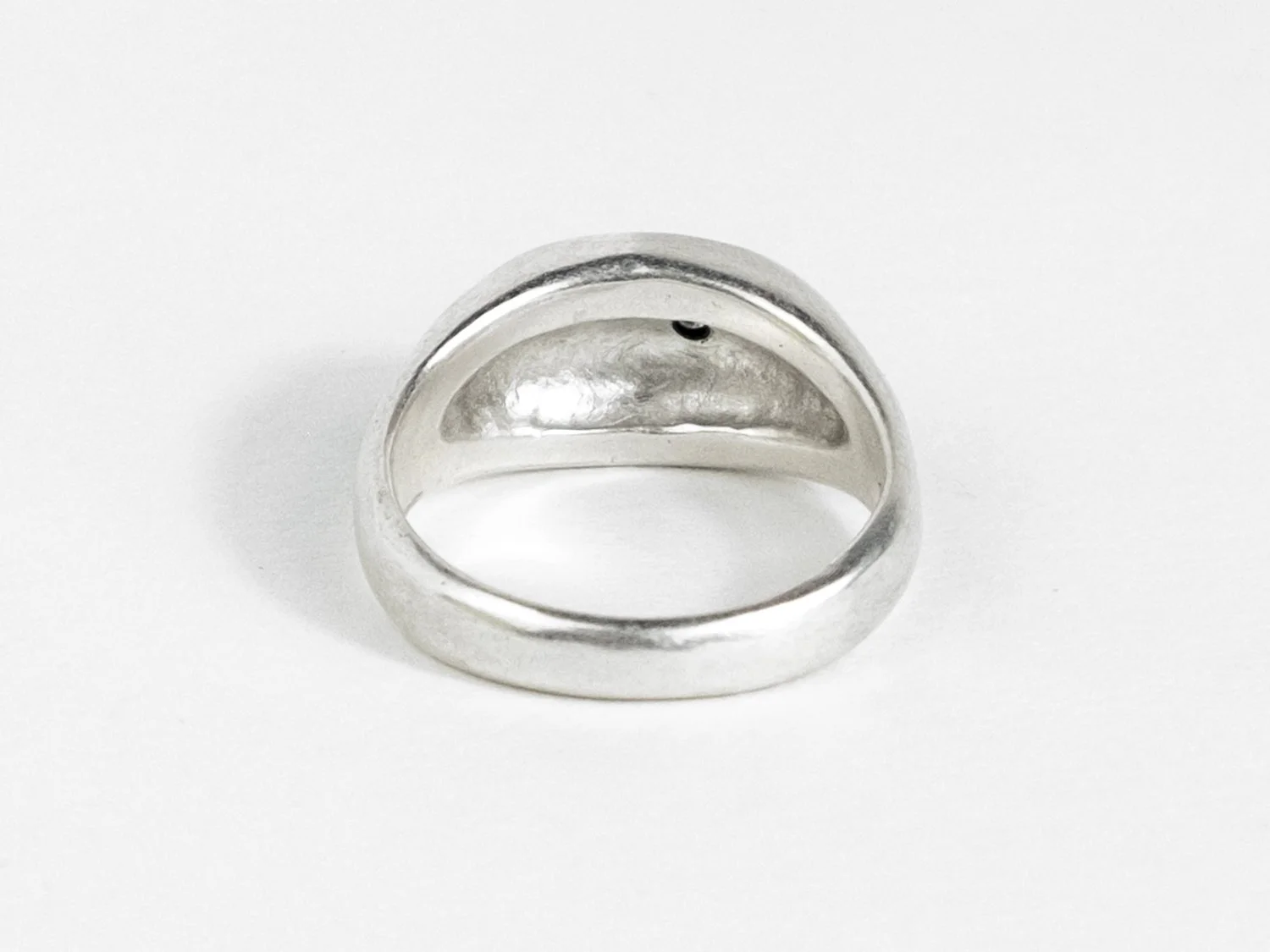 Back view of a wide silver signet ring